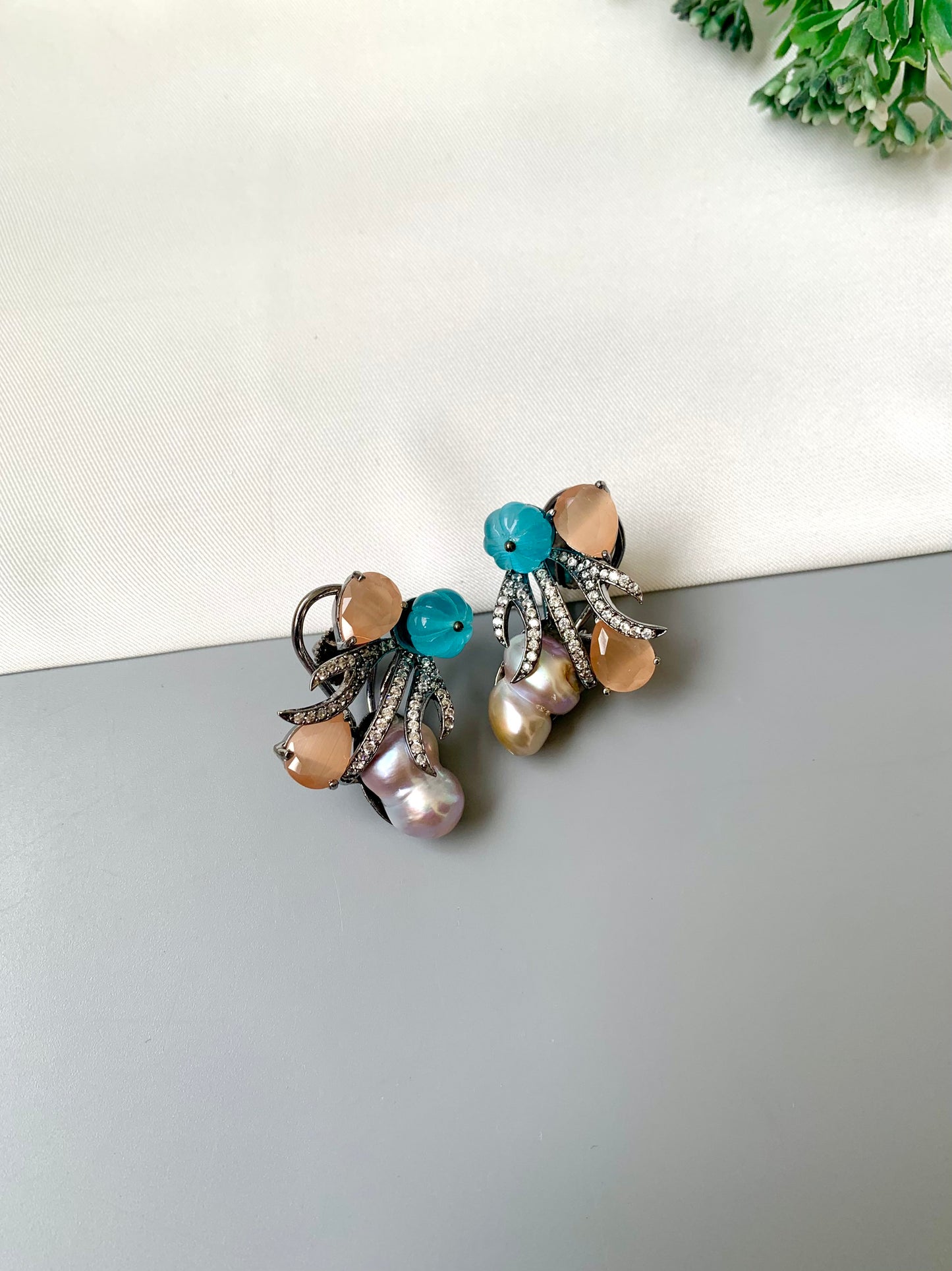 Petra orange onyx baroque pearl studs in rhodium oxidized finish with melon beads and American diamonds