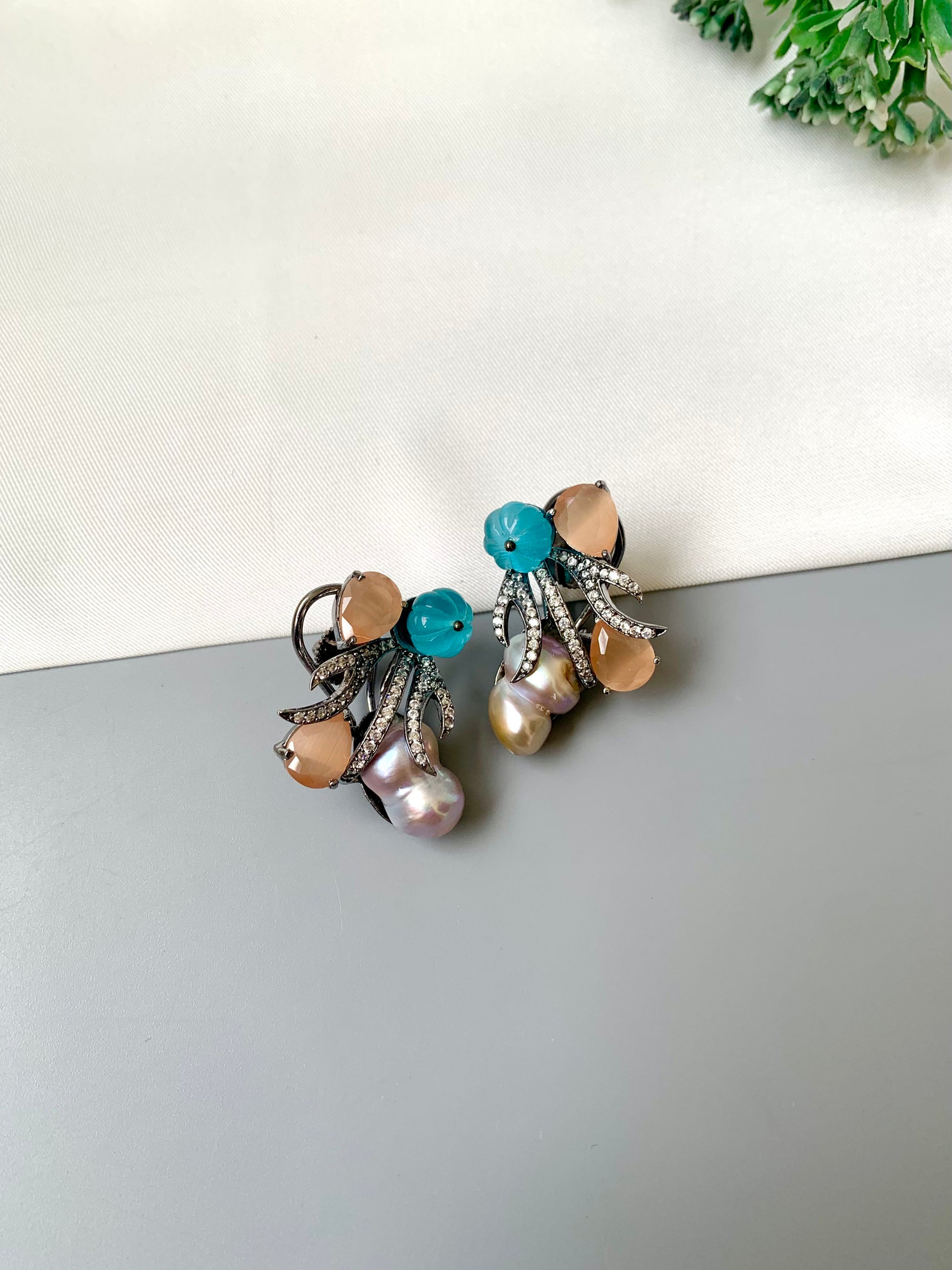 Petra orange onyx baroque pearl studs in rhodium oxidized finish with melon beads and American diamonds