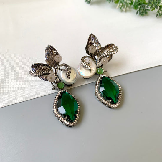 Krisha designer earrings in rhodium finish with baroque pearls, emerald and onyx gemstones