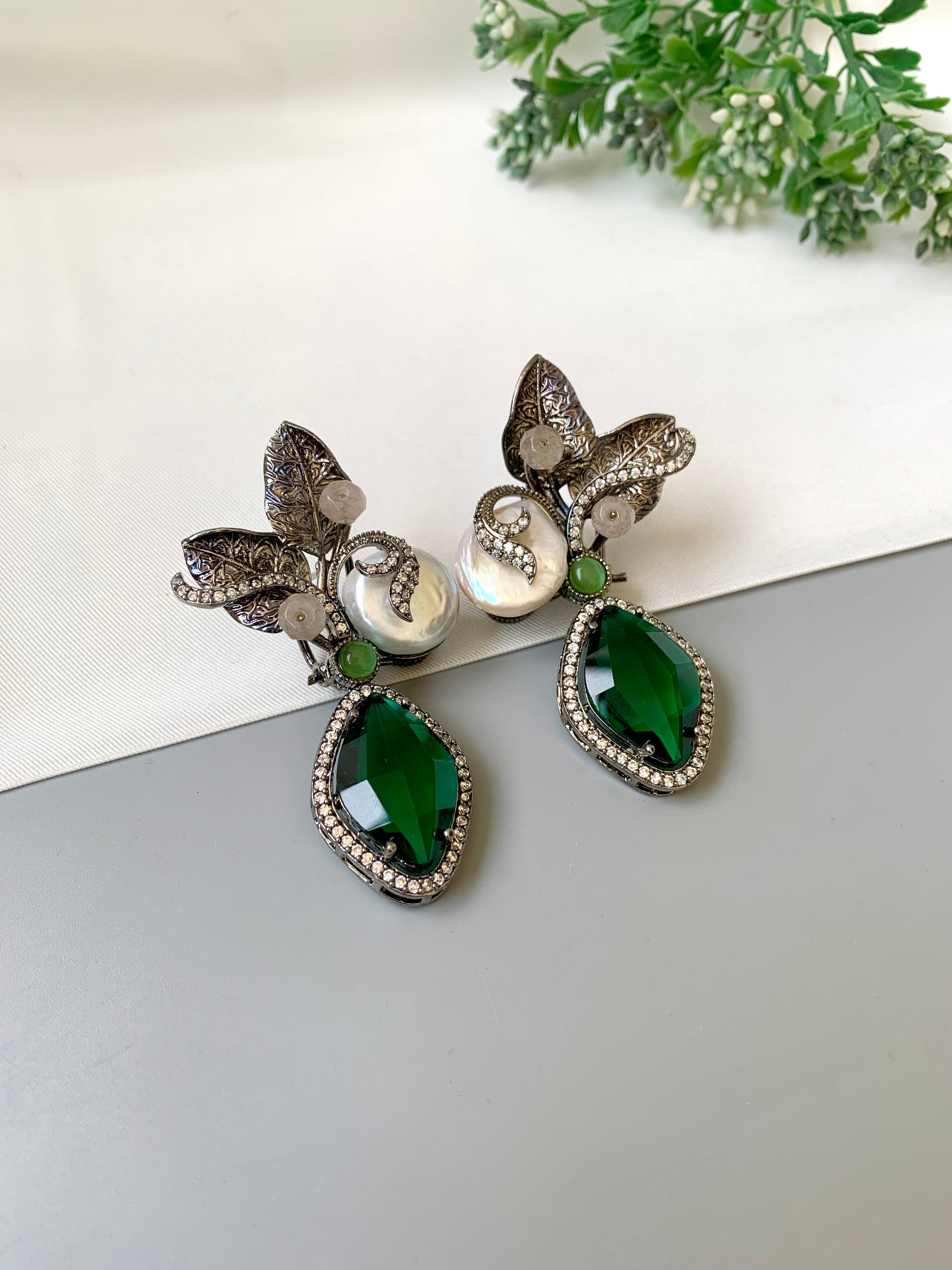 Krisha designer earrings in rhodium finish with baroque pearls, emerald and onyx gemstones