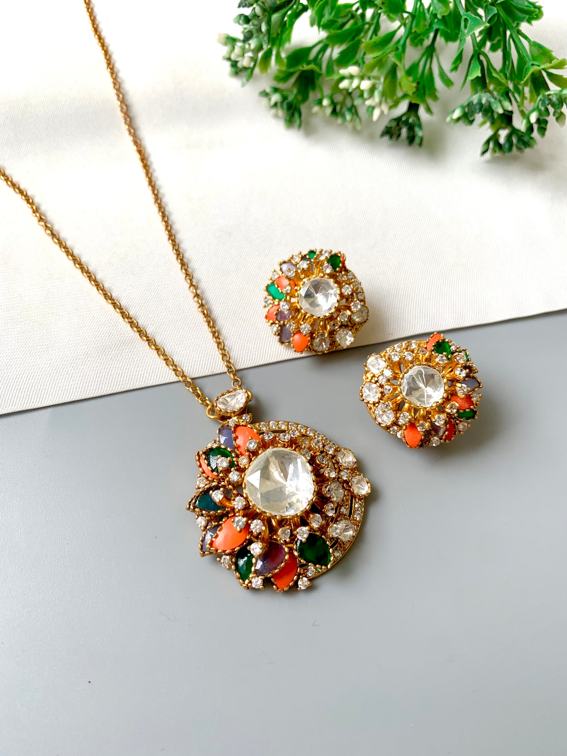 "Video of Raniyah multicolor pendant set with antique gold polish and mirror-cut center, showcasing detailed craftsmanship"