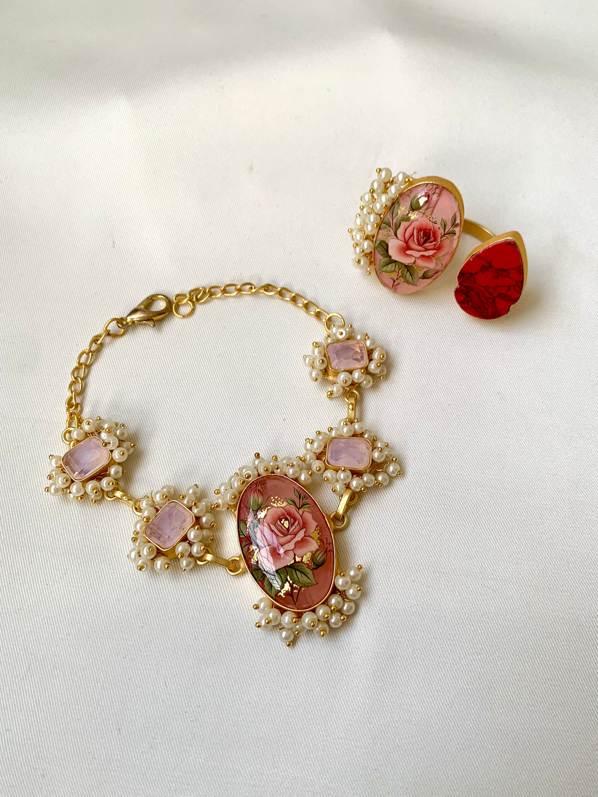 Shehnai Combo Set featuring handcrafted gold plated bracelet and adjustable ring with pearls, ruby and hand painted Tansa beads