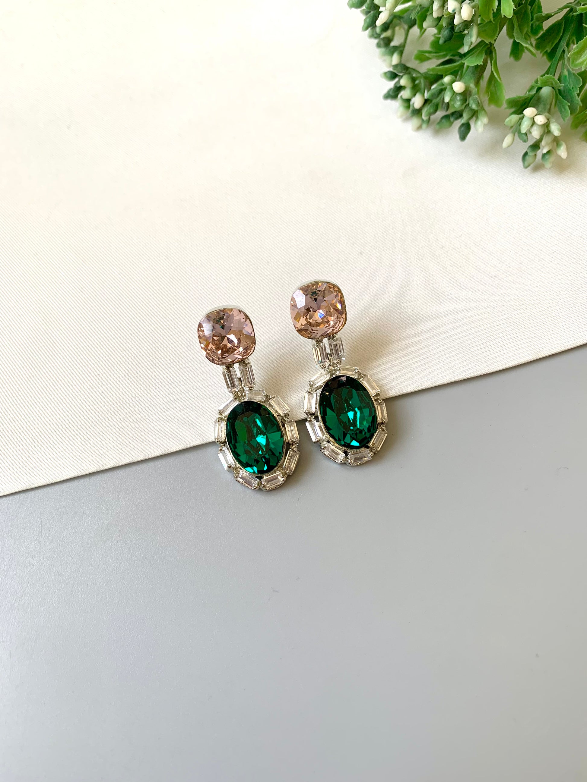 Handcrafted rhodium plated platinum finish earrings with baguette stones and Swarovski crystals in emerald tone