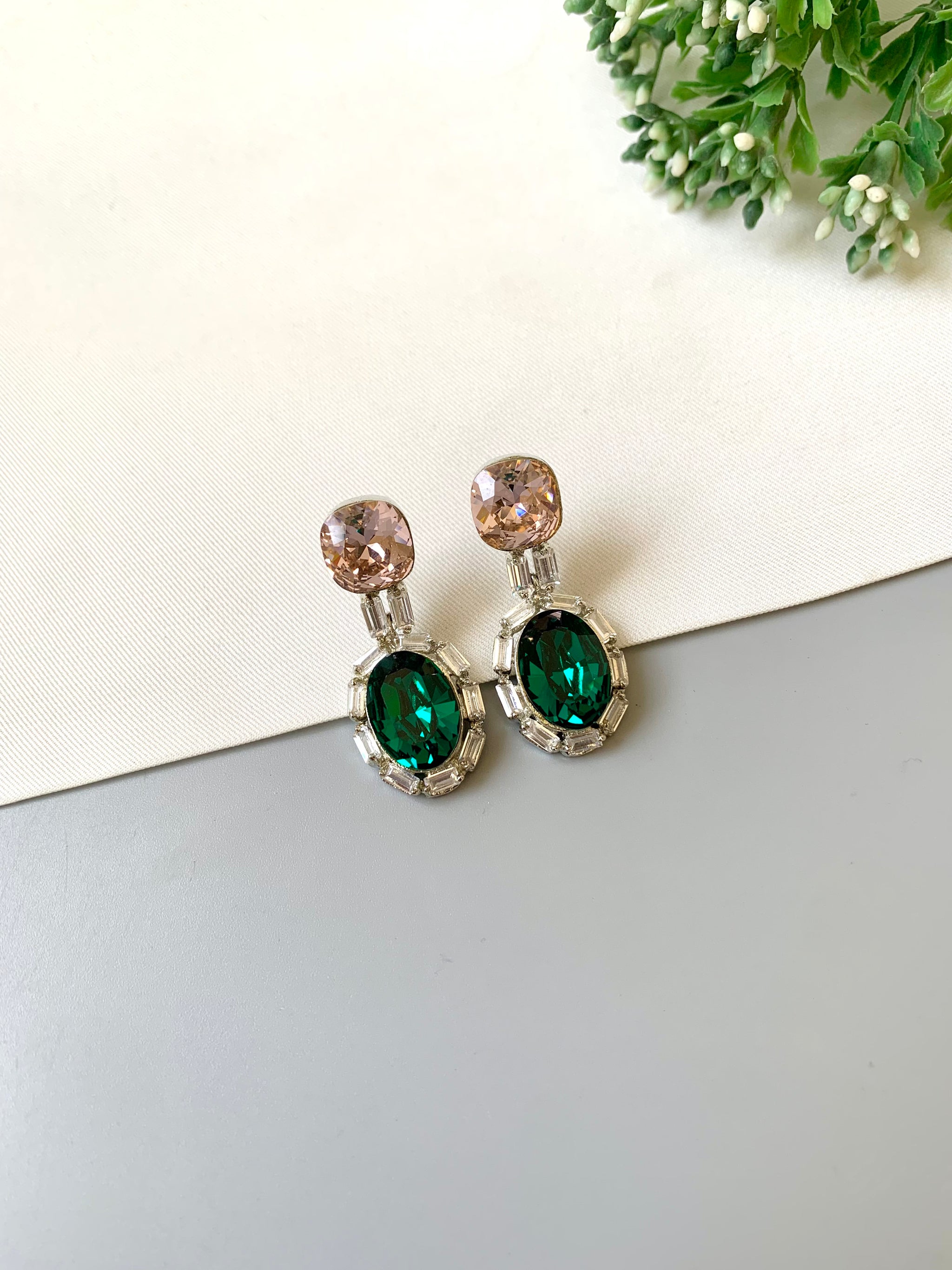 Handcrafted rhodium plated platinum finish earrings with baguette stones and Swarovski crystals in emerald tone