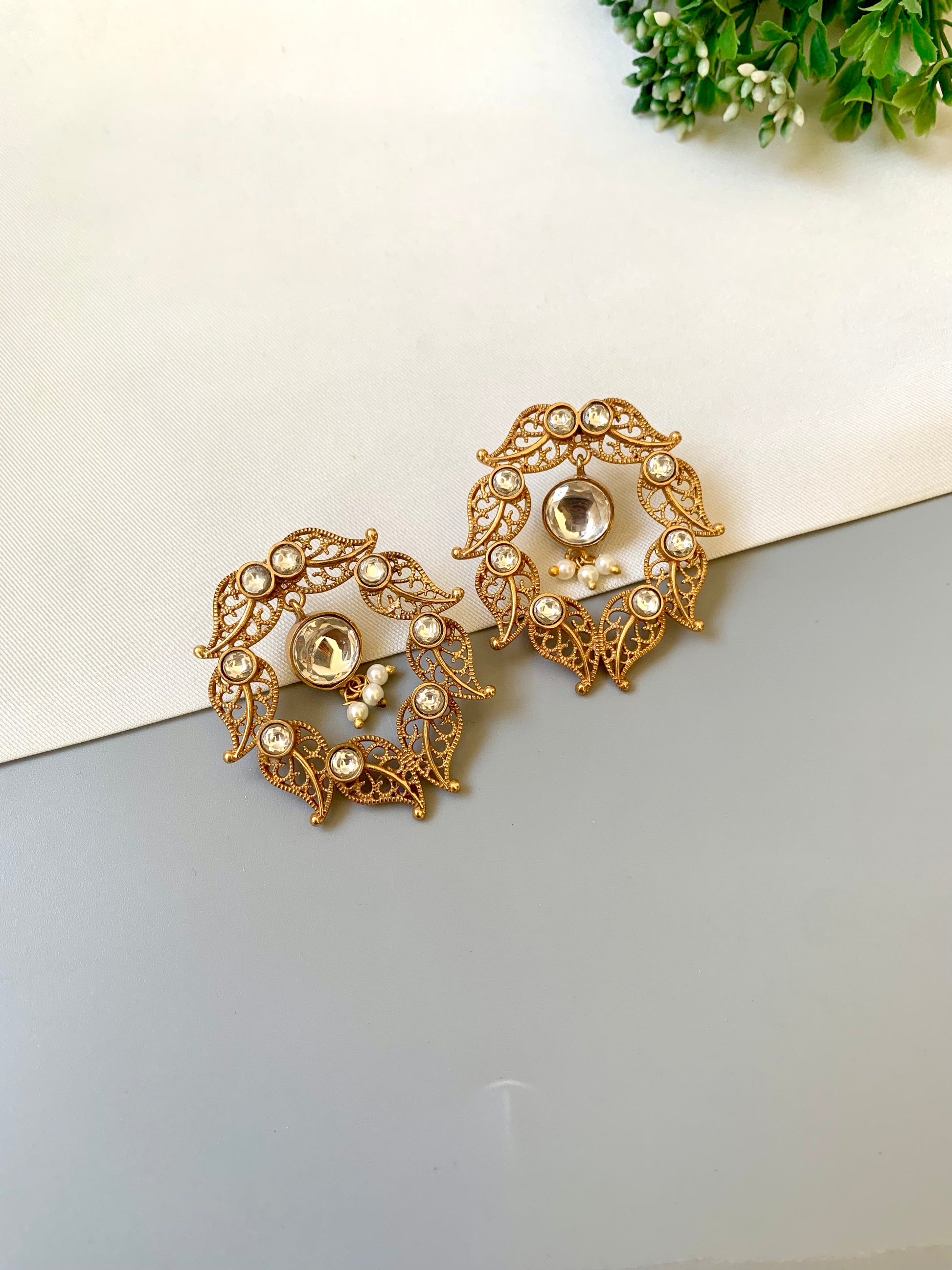Handcrafted 22kt gold plated designer earrings with Polki Kundan stones and semi precious pearl detailing