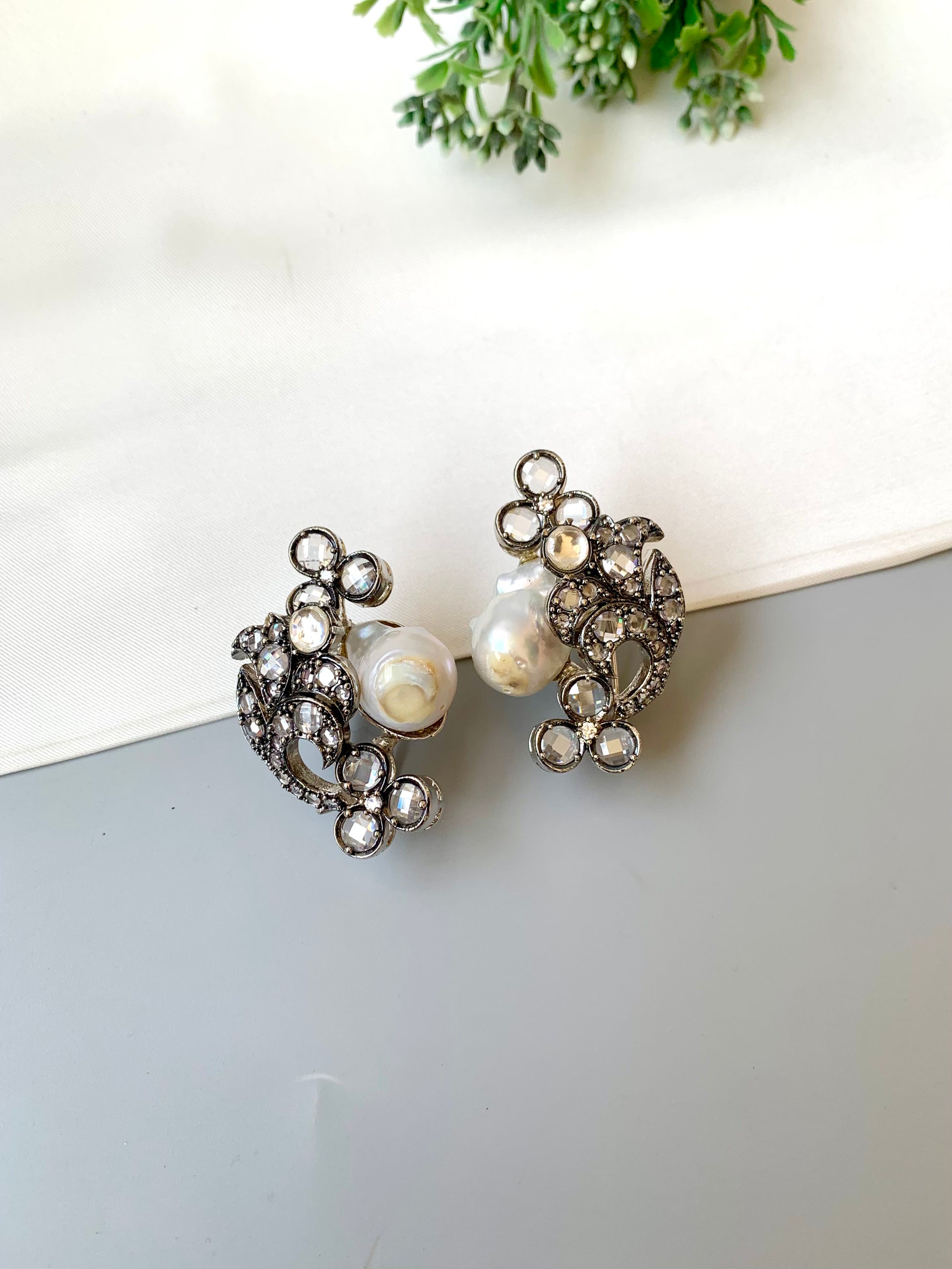 Raima baroque pearl earrings in rhodium plating with reverse american diamonds