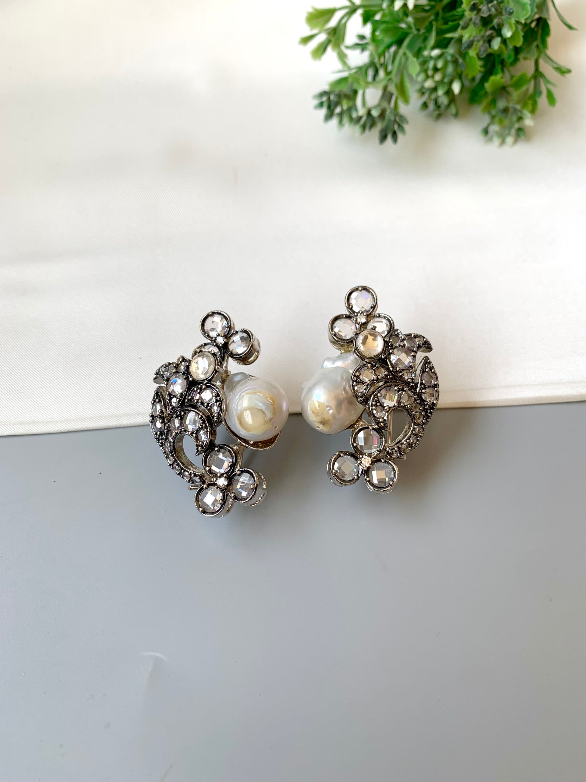 Raima baroque pearl earrings in rhodium plating with reverse american diamonds