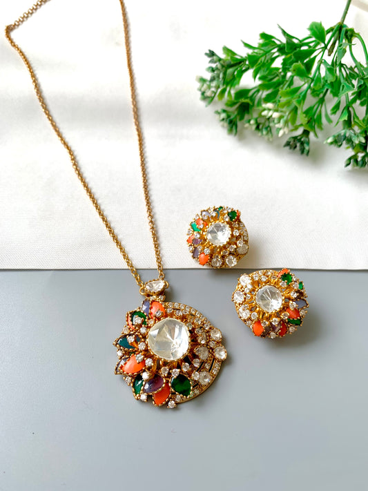 "Raniyah pendant set in multicolor stones and antique gold, shown in flat lay style by Zamal Jewels"

