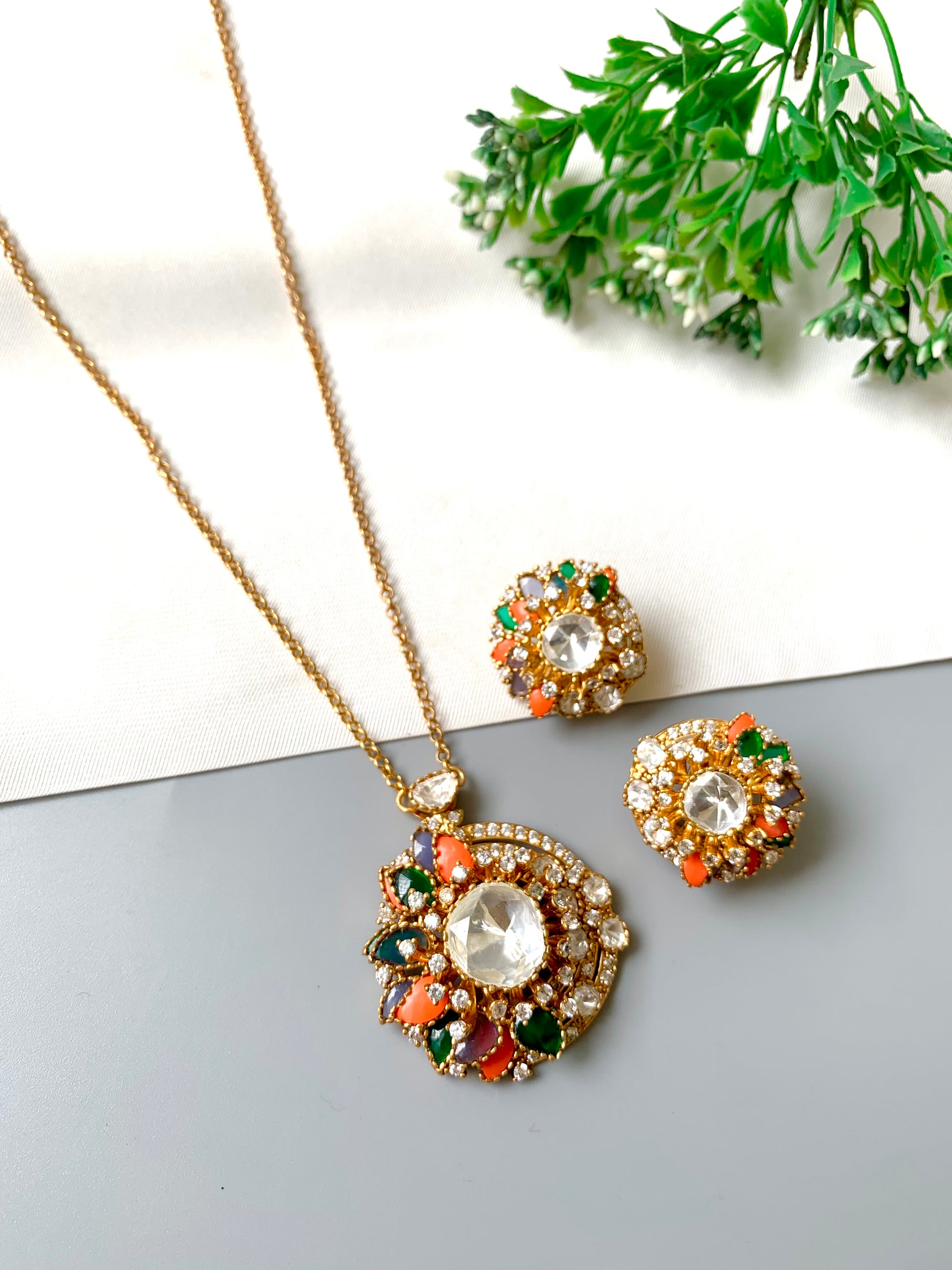 "Close-up of Raniyah pendant with mirror-cut center and multicolored semi-precious stones in antique finish"