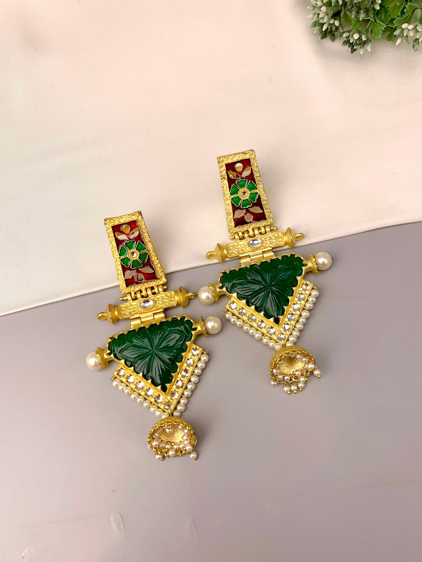 Roniya handcrafted jhumkas in 22kt gold plating with hand carved emerald polki kundan pearls and meena work