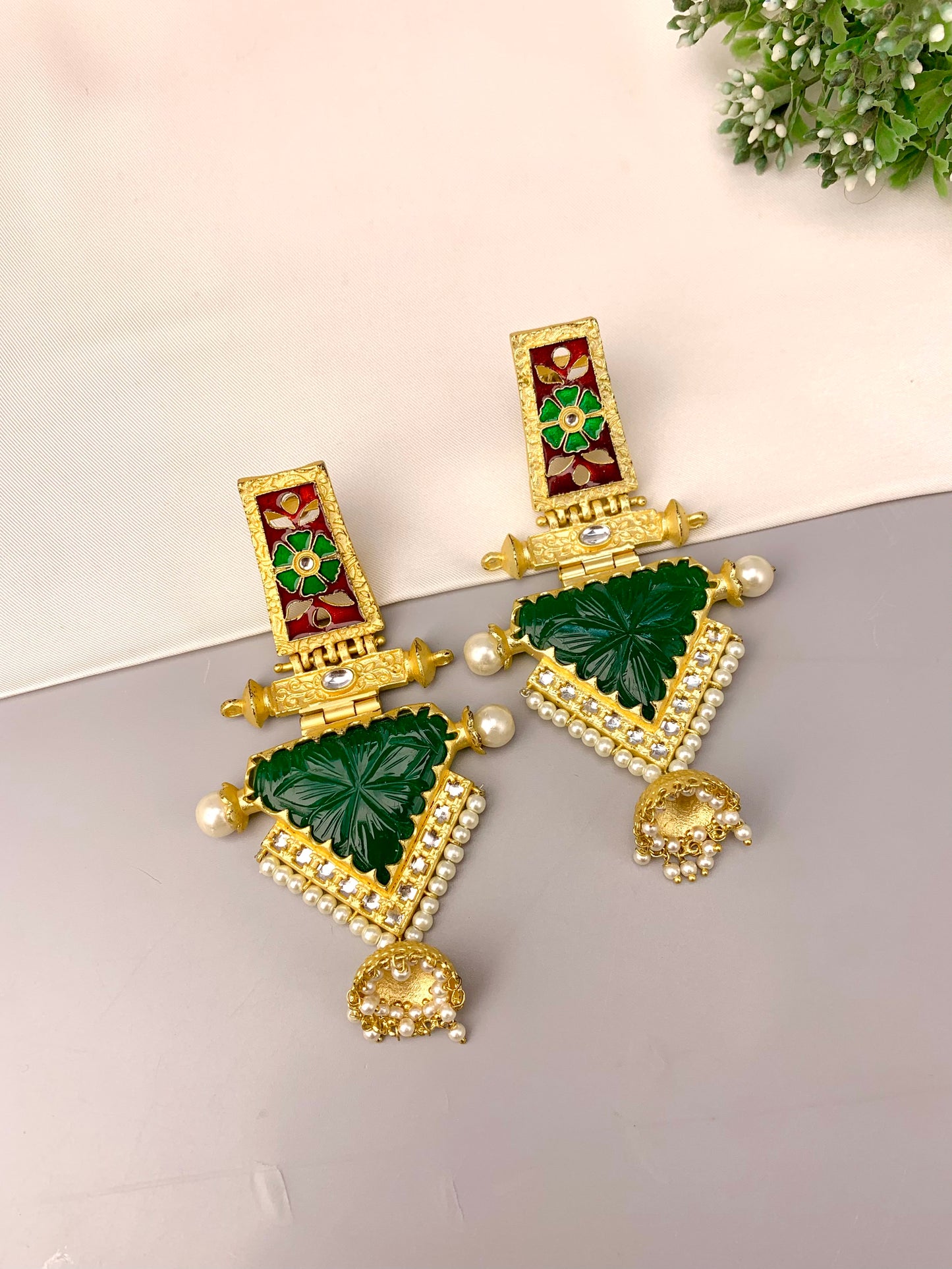 Roniya handcrafted jhumkas in 22kt gold plating with hand carved emerald polki kundan pearls and meena work