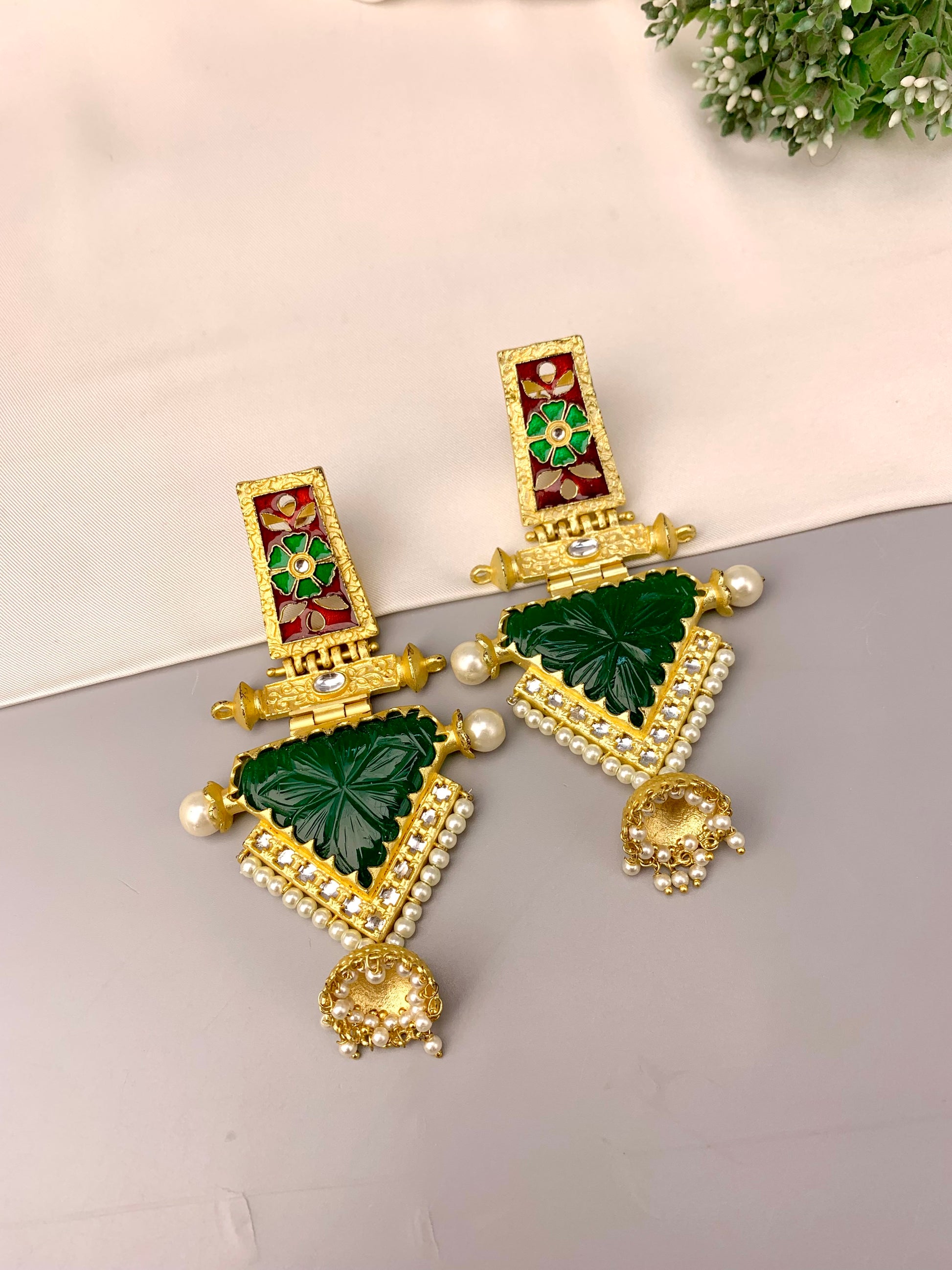 Roniya handcrafted jhumkas in 22kt gold plating with hand carved emerald polki kundan pearls and meena work