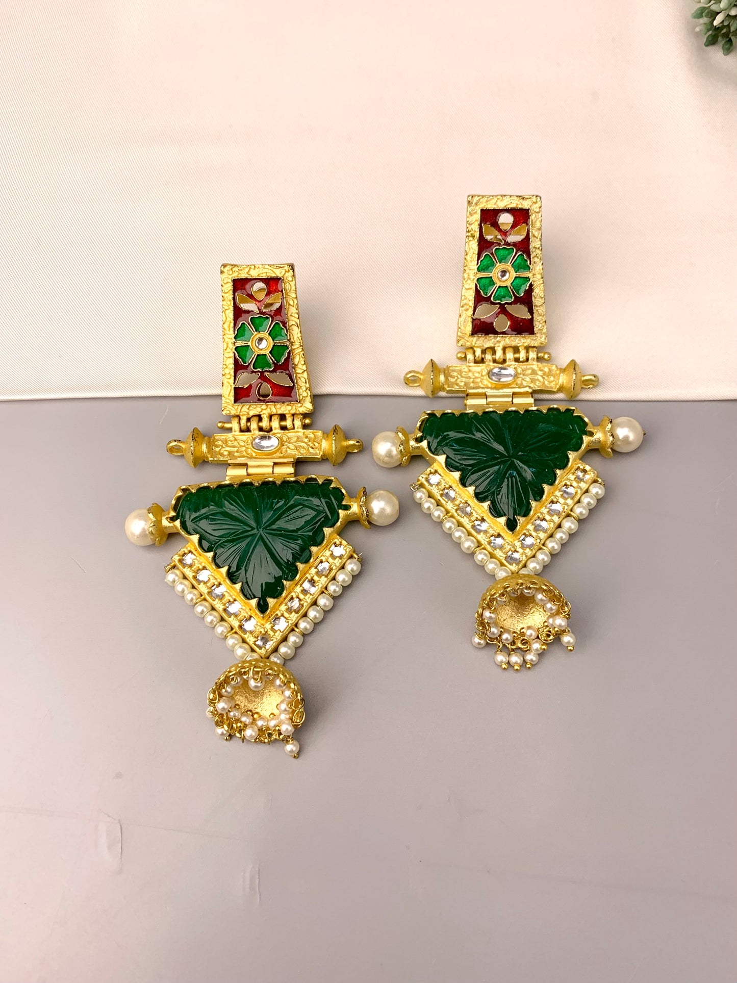 Roniya handcrafted jhumkas in 22kt gold plating with hand carved emerald polki kundan pearls and meena work