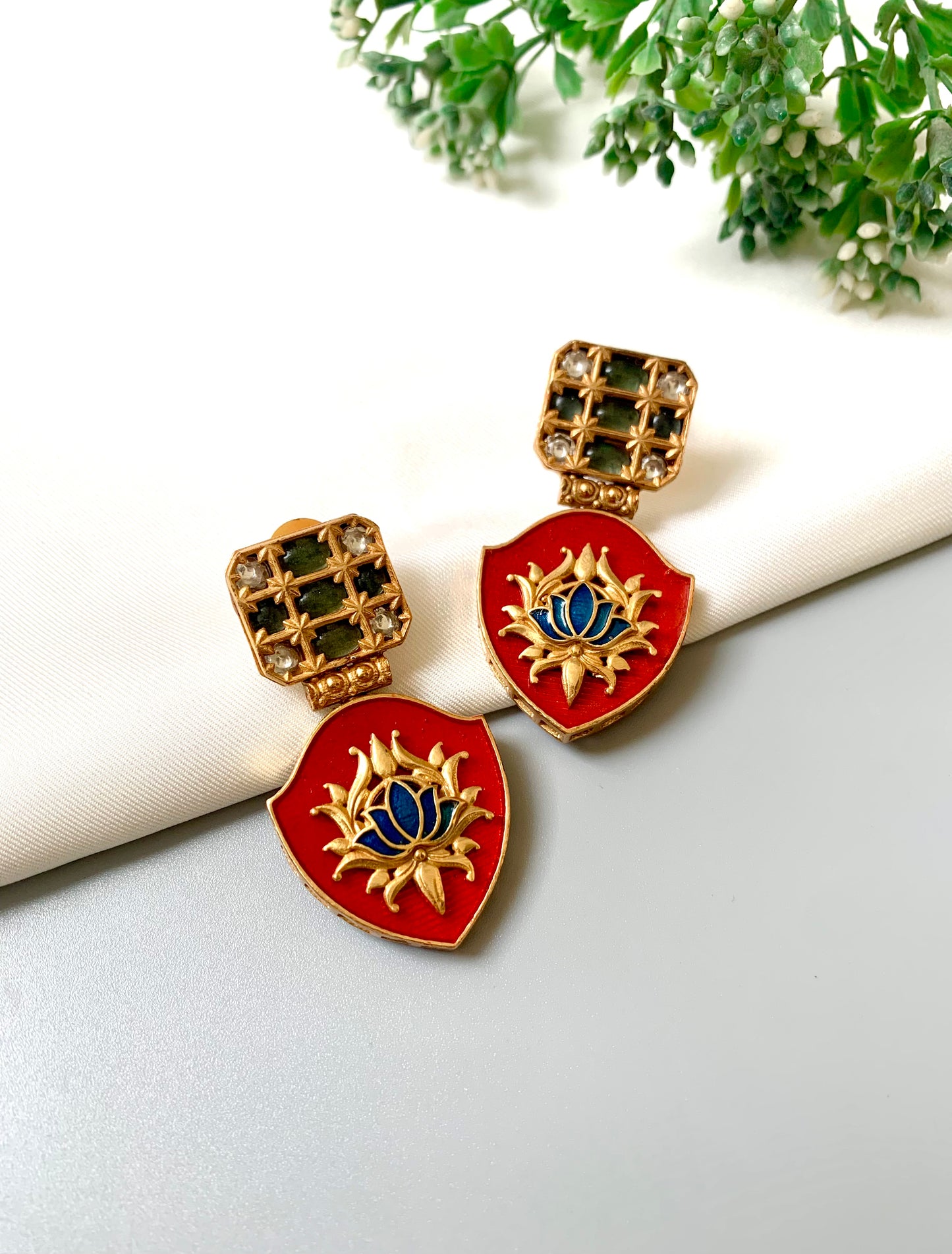 Close-up of Rosina Earrings with Polki Diamonds and lotus motif in hand-painted Meena