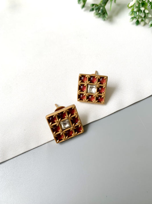 Pair of square ruby grid studs with 22kt gold plating and central Polki Kundan stone