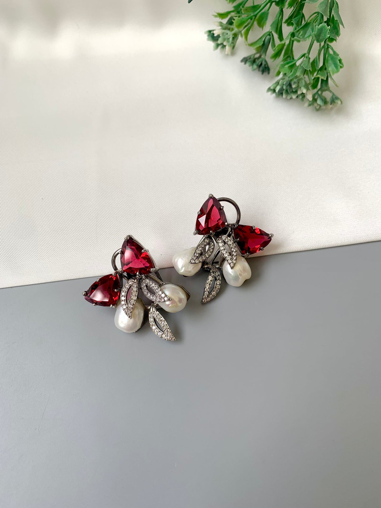 Ruby designer studs in rhodium diamond finish with baroque pearls and ruby stones