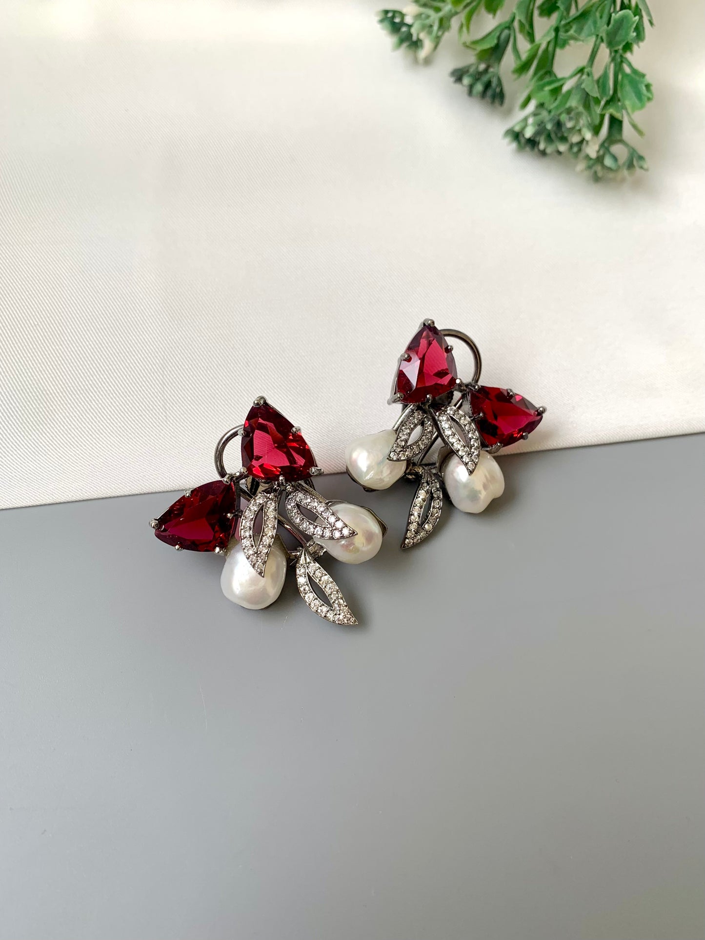Ruby designer studs in rhodium diamond finish with baroque pearls and ruby stones