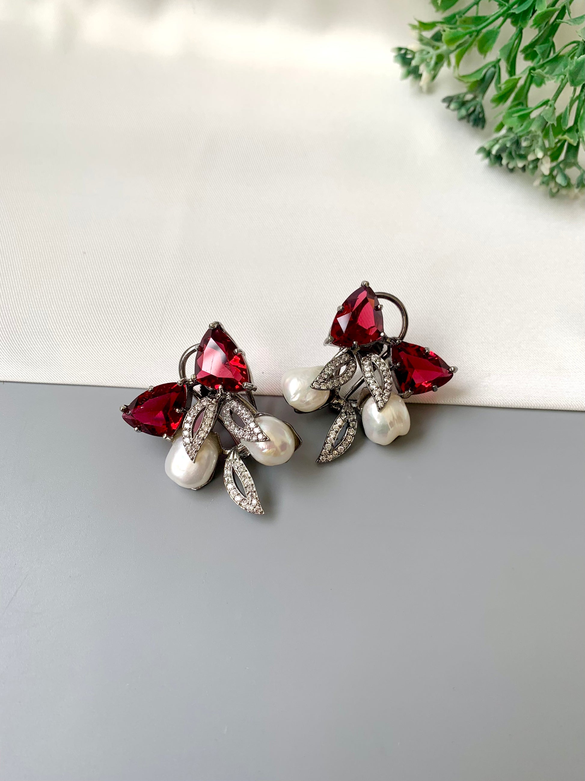 Ruby designer studs in rhodium diamond finish with baroque pearls and ruby stones