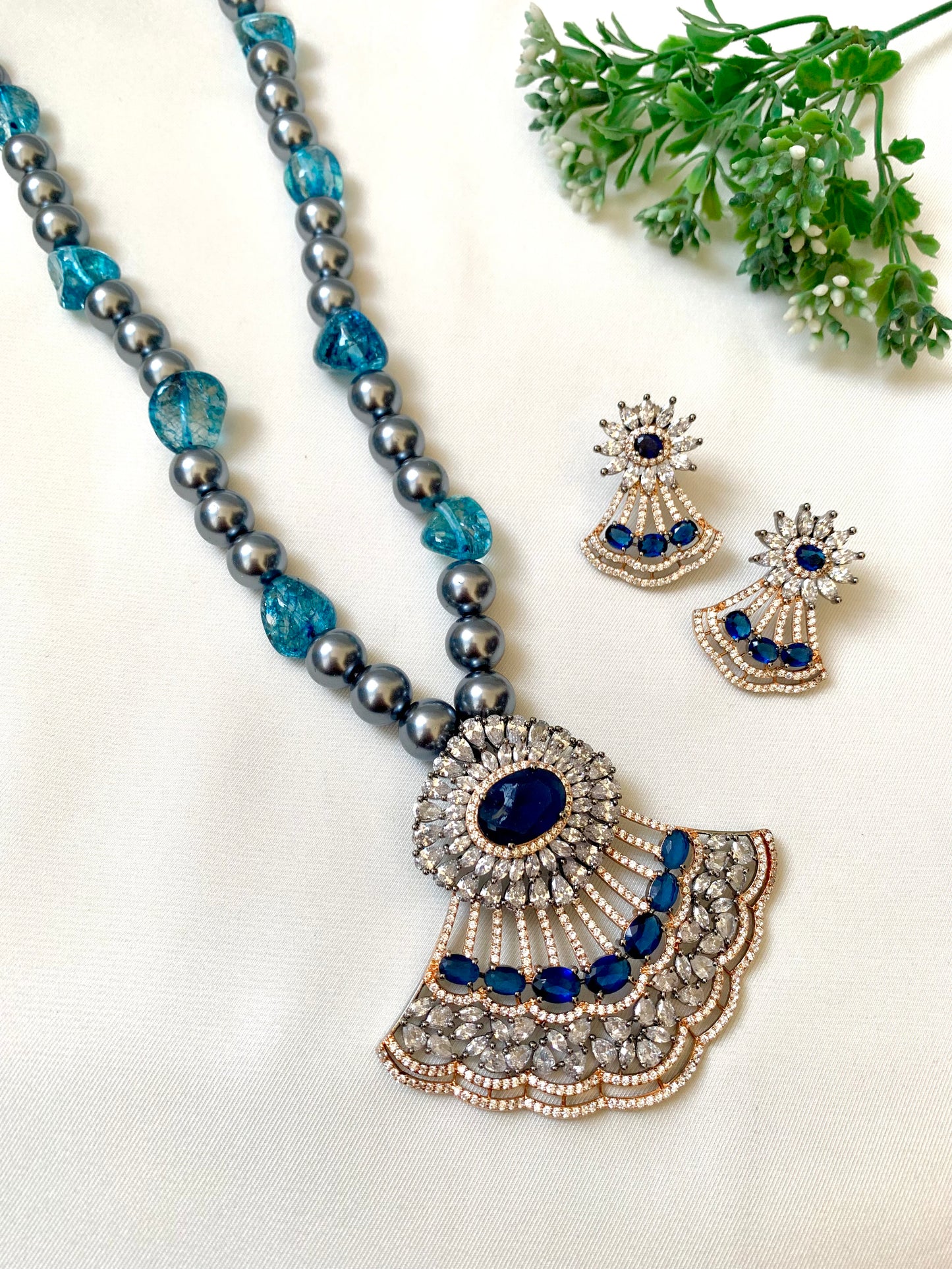 Saera sapphire maala set in black rose gold plating with American diamonds and pearls
