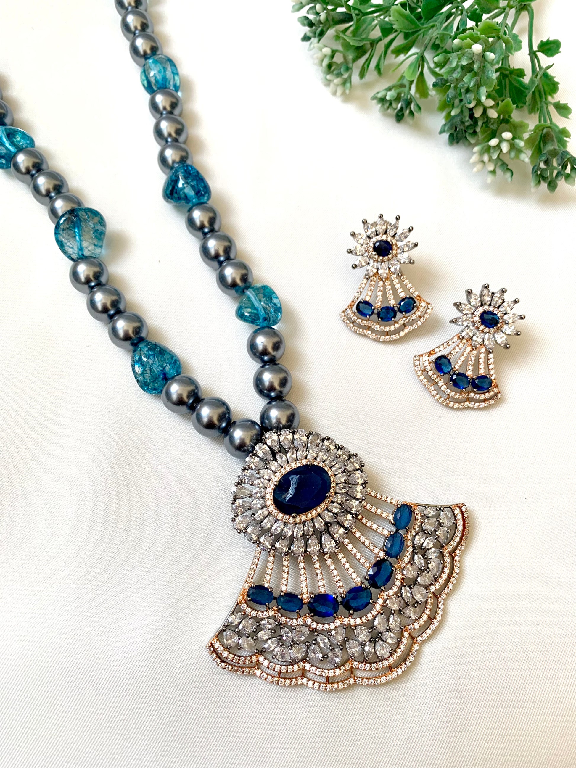 Saera sapphire maala set in black rose gold plating with American diamonds and pearls