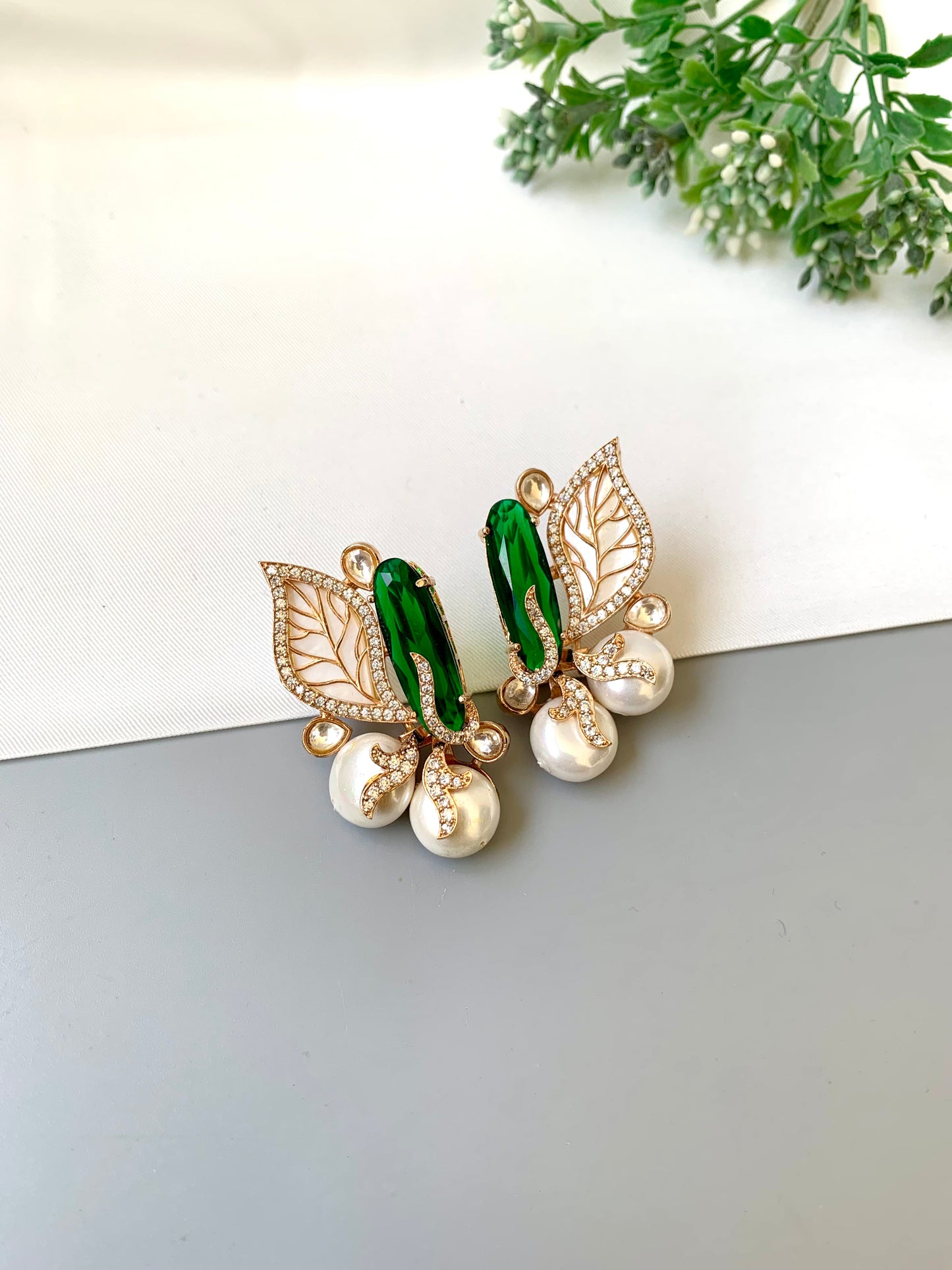Saga emerald studs in rose gold plating with polki kundan, baroque pearls and mother of pearl