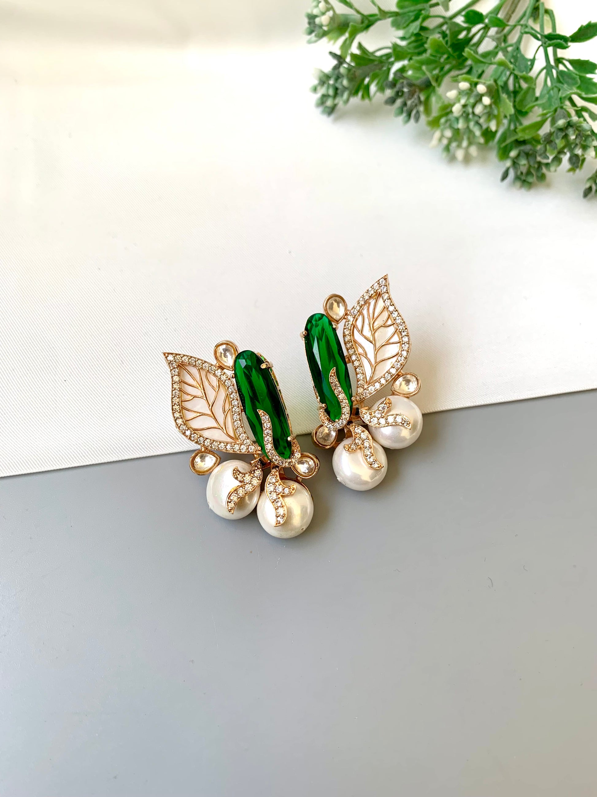 Saga emerald studs in rose gold plating with polki kundan, baroque pearls and mother of pearl