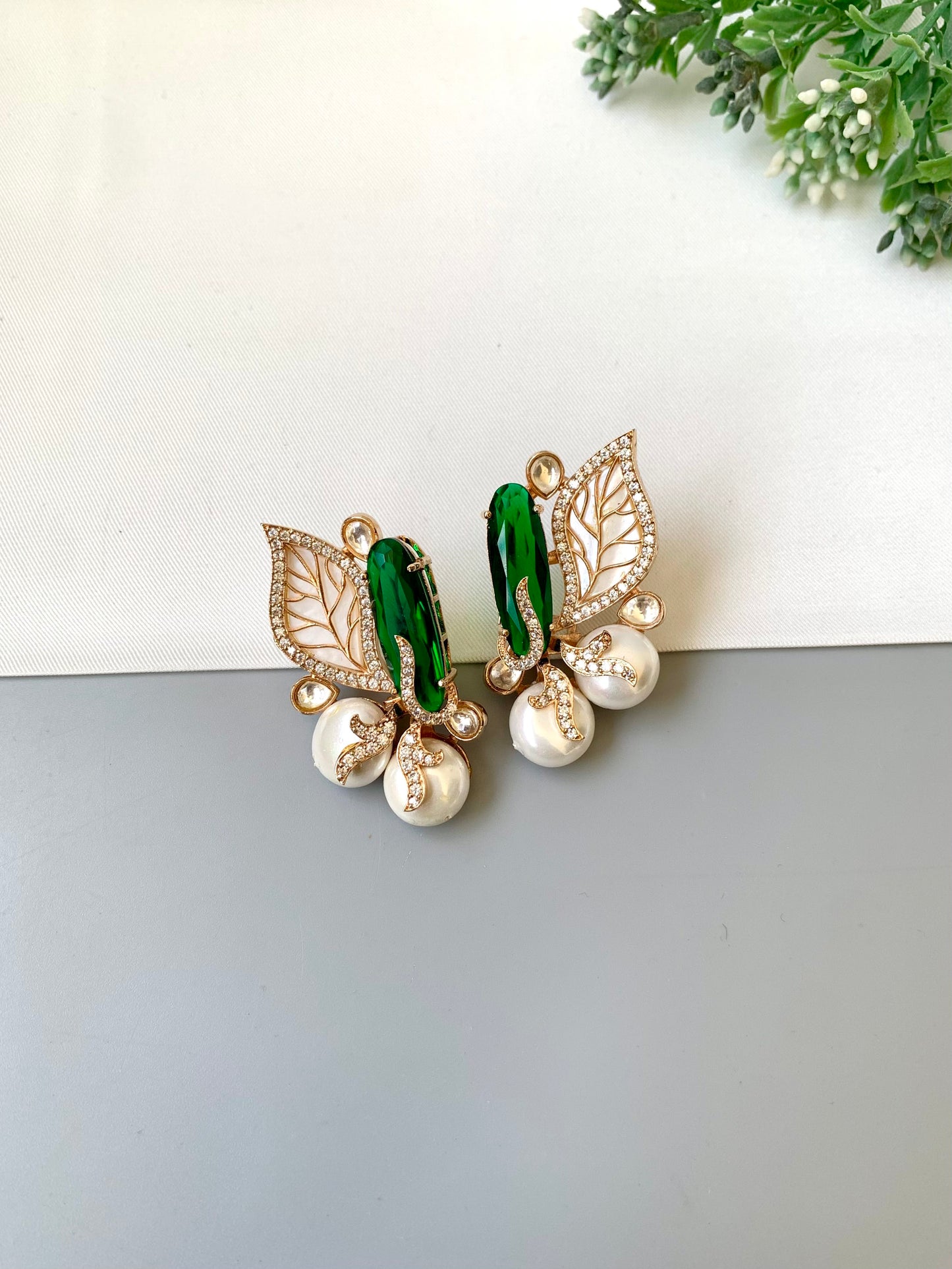 Saga emerald studs in rose gold plating with polki kundan, baroque pearls and mother of pearl