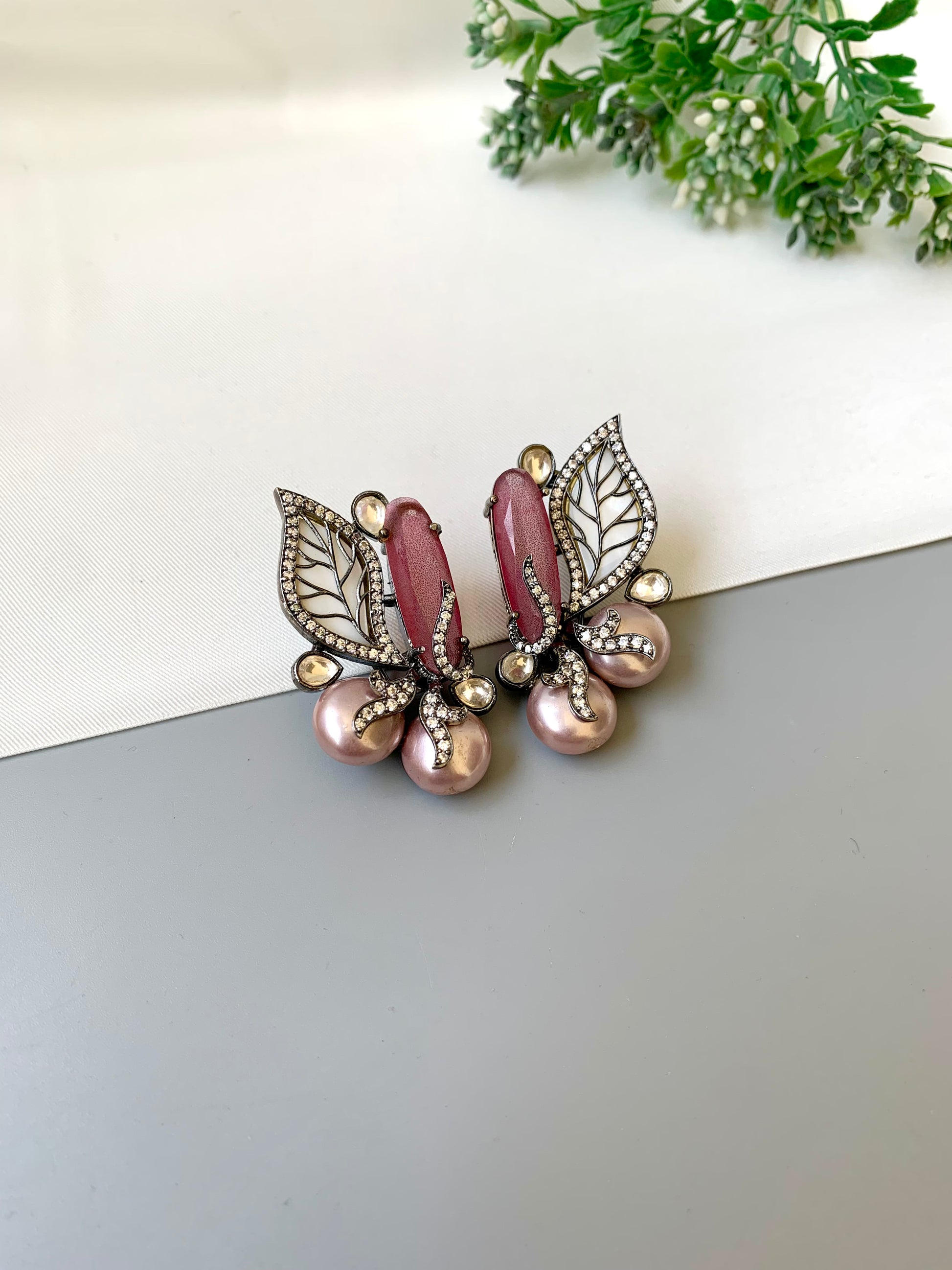Saga pink studs in rhodium plating with polki kundan, baroque pearls and mother of pearl