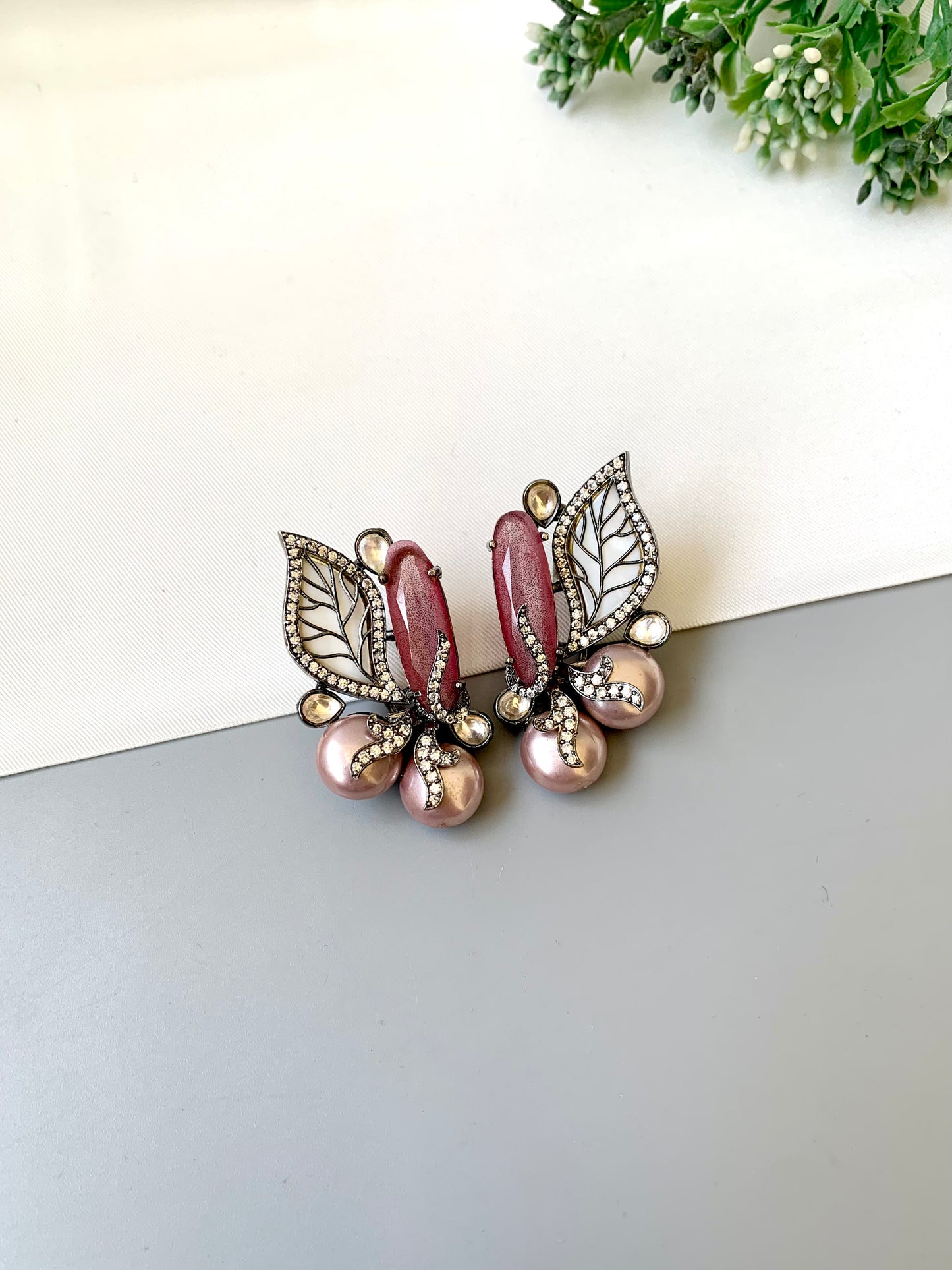 Saga pink studs in rhodium plating with polki kundan, baroque pearls and mother of pearl