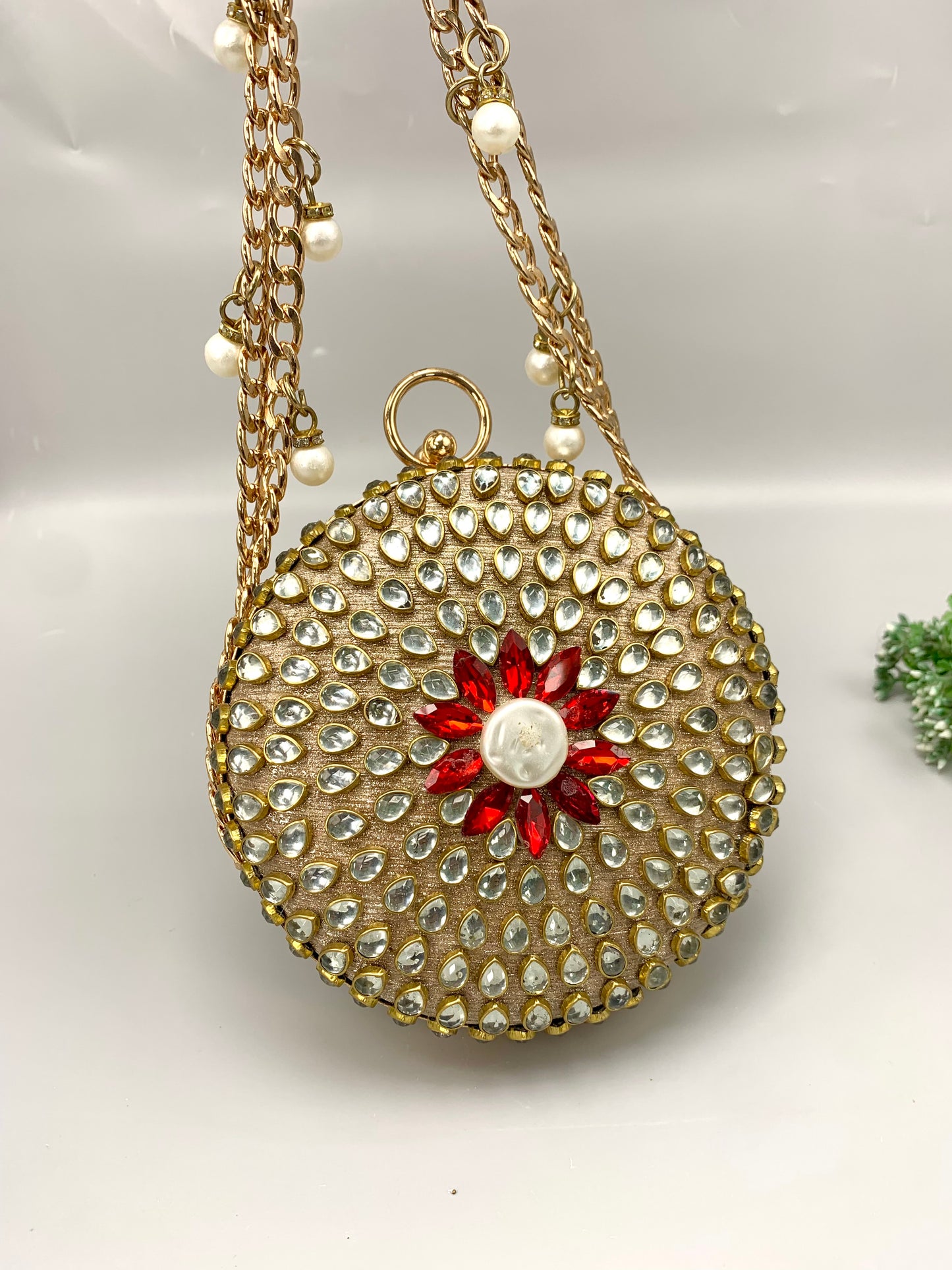 Sahar handcrafted round clutch in 22kt gold plating with kundan pearls and pearl sling detailing