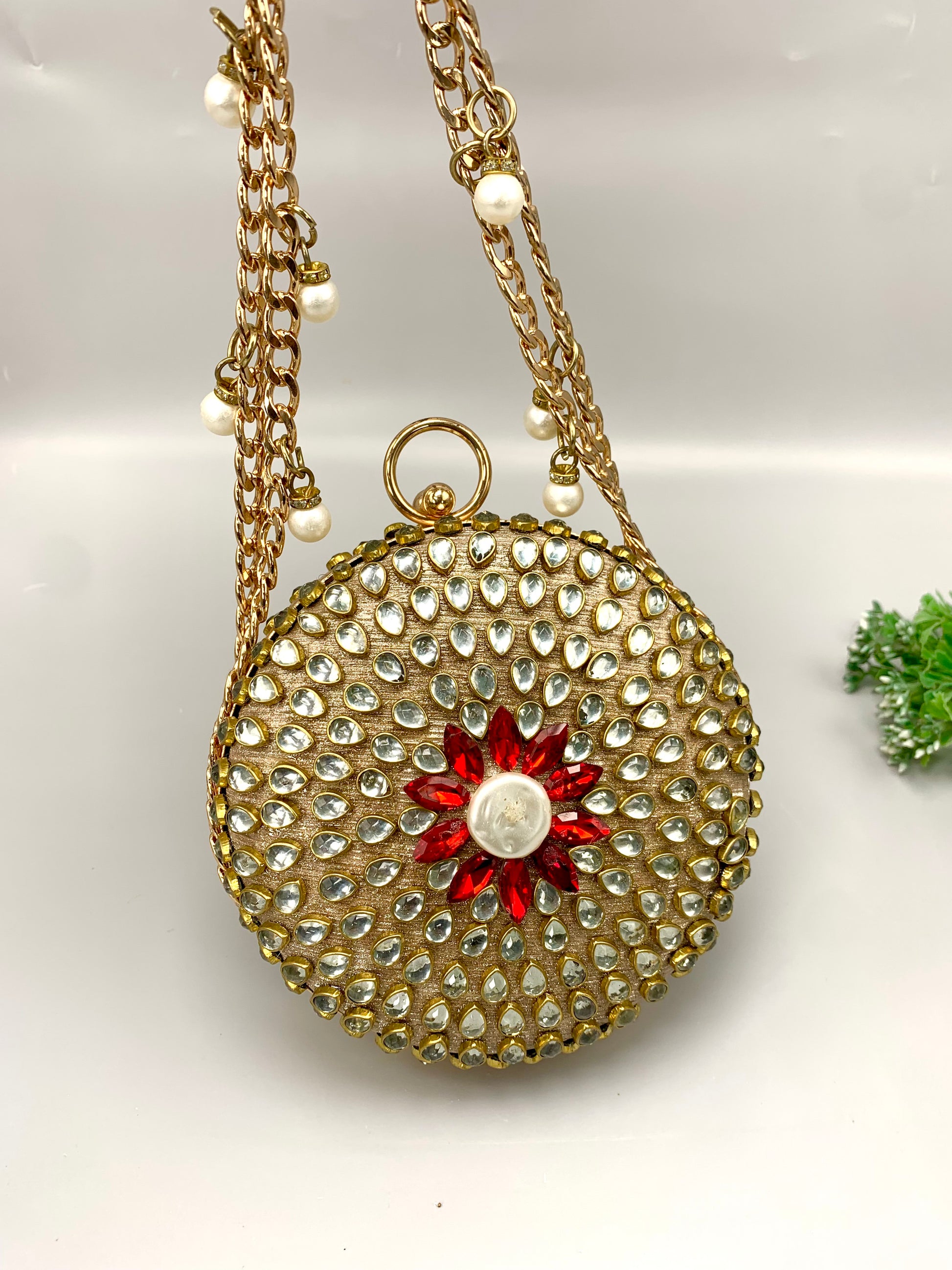 Sahar handcrafted round clutch in 22kt gold plating with kundan pearls and pearl sling detailing