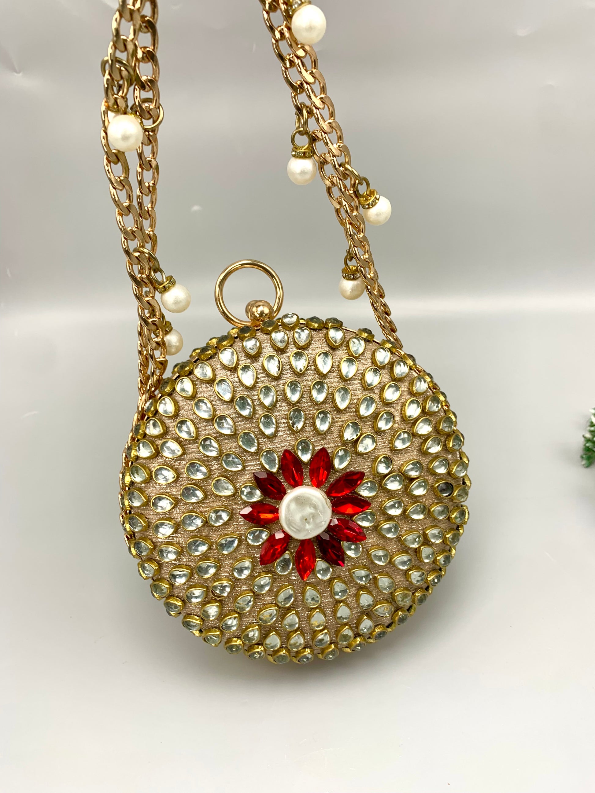 Sahar handcrafted round clutch in 22kt gold plating with kundan pearls and pearl sling detailing