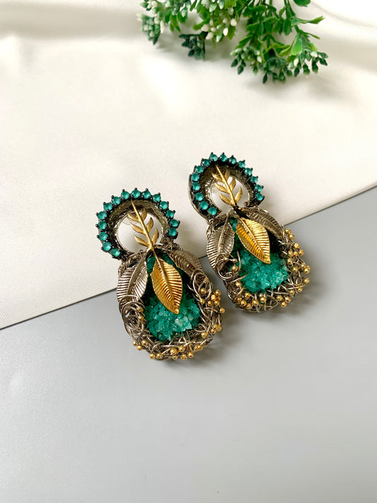Rhodium plated handcrafted earrings with semi-precious green gemstones and metallic leaf accents from Zamal Jewels