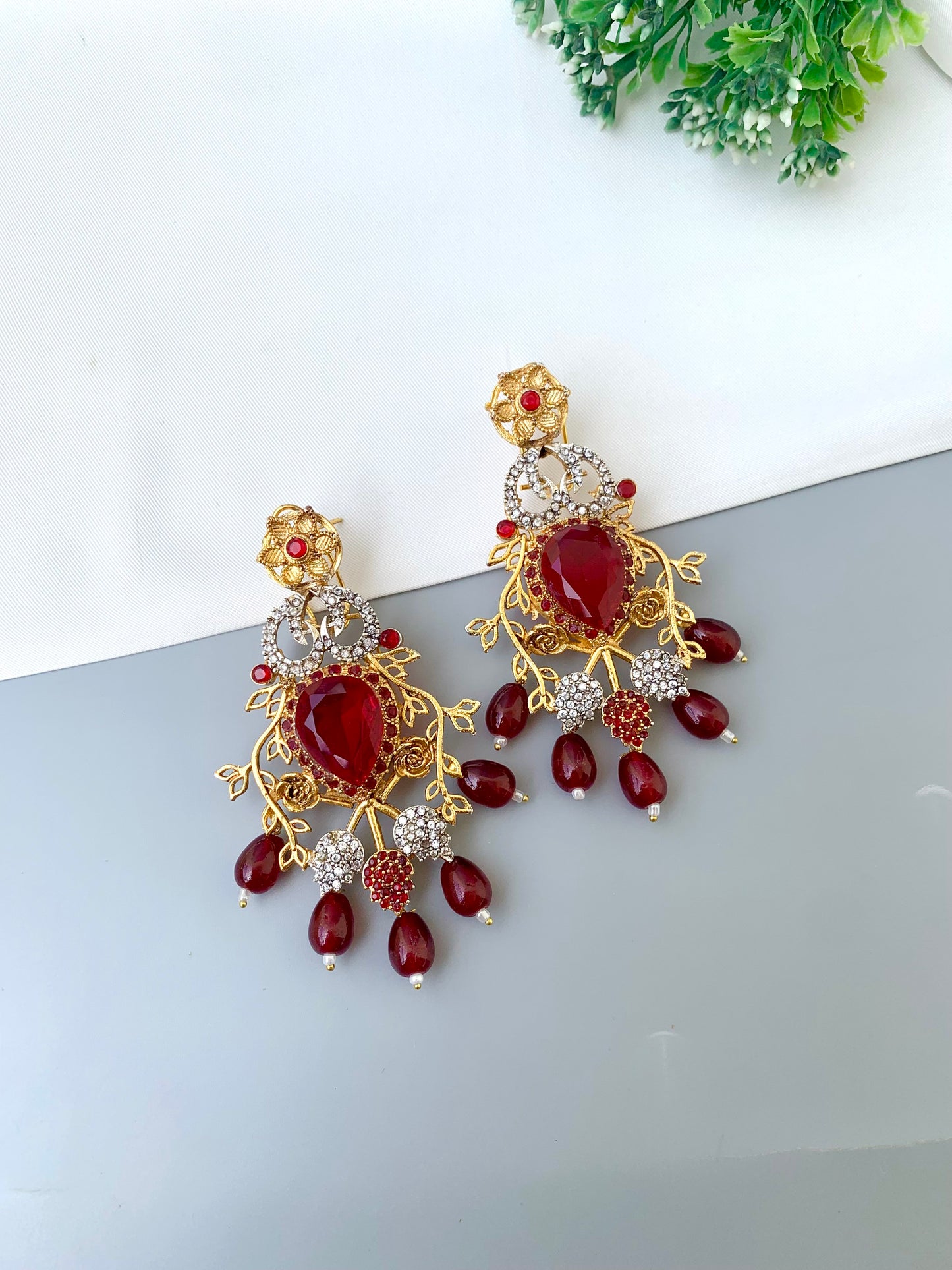 Sakeena ruby earrings in 22kt gold plating with American diamonds