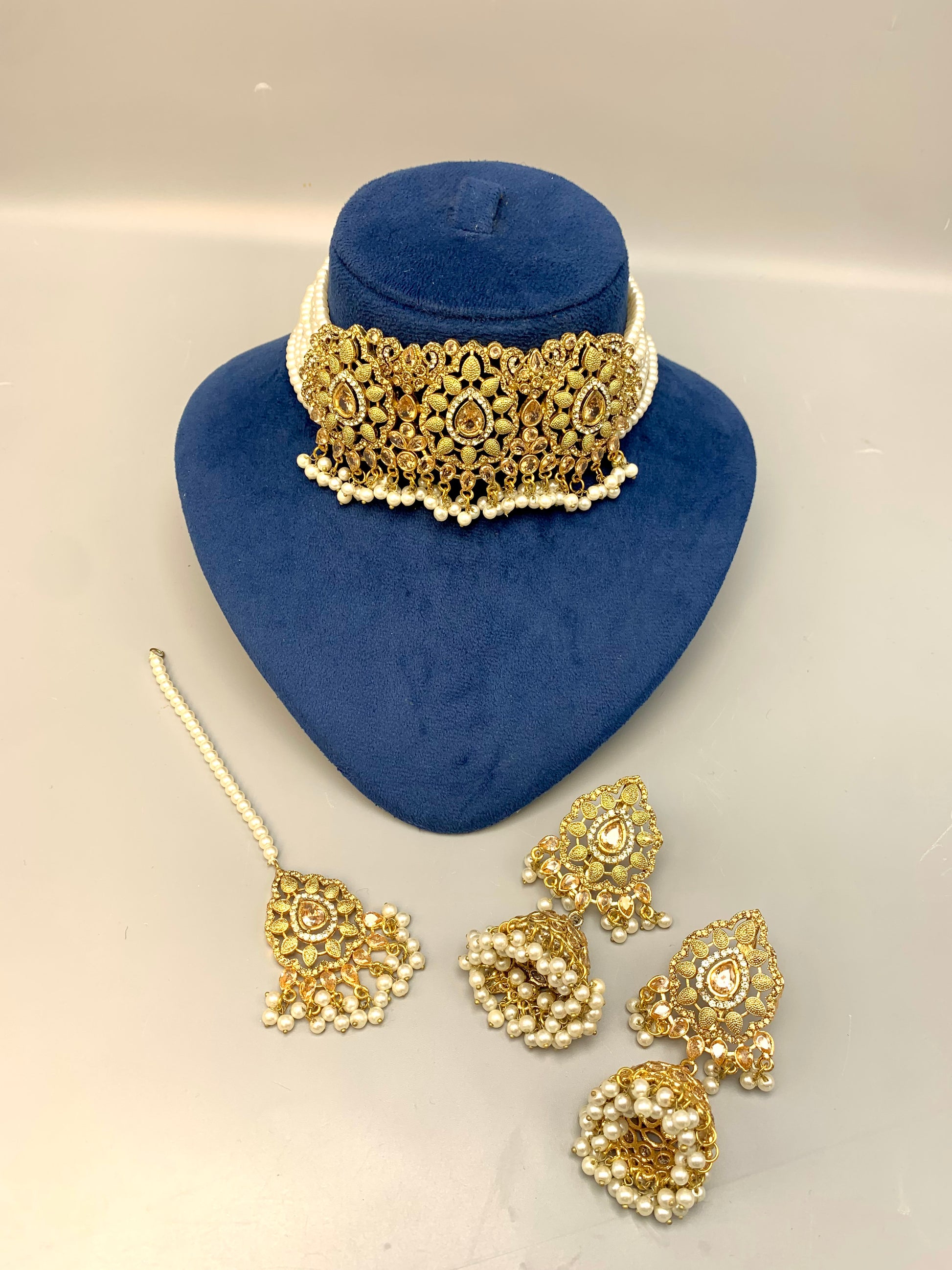 Saliha handcrafted bridal choker set in 22kt gold plating with American diamonds, semi-precious Polki, champagne stones, pearls and matching tikka