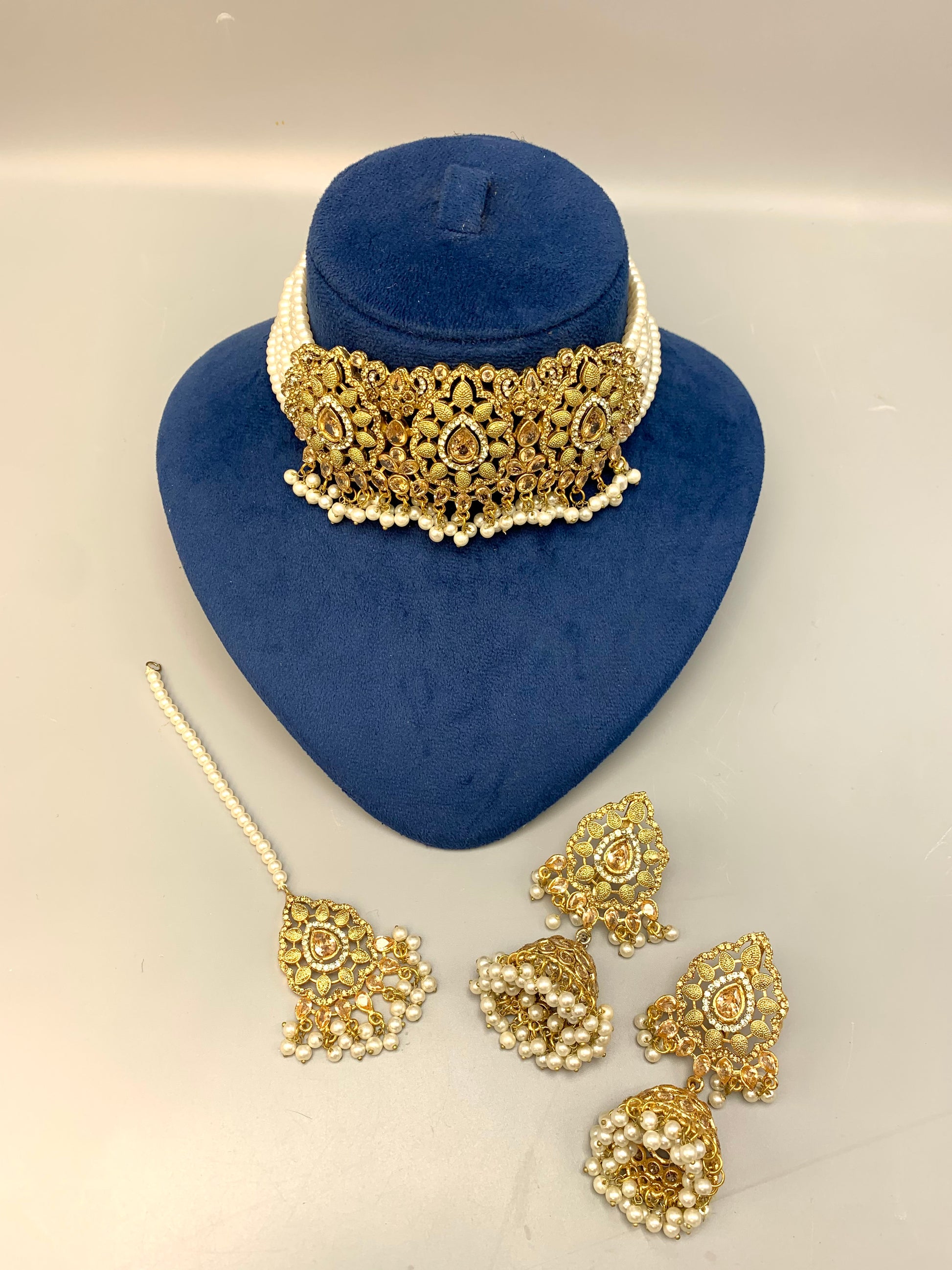 Saliha handcrafted bridal choker set in 22kt gold plating with American diamonds, semi-precious Polki, champagne stones, pearls and matching tikka