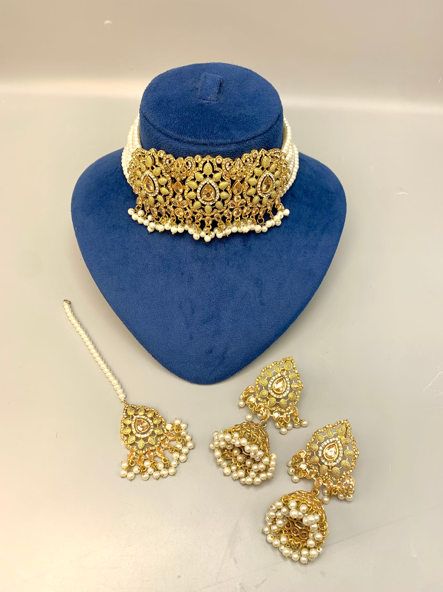Saliha handcrafted bridal choker set in 22kt gold plating with American diamonds, semi-precious Polki, champagne stones, pearls and matching tikka
