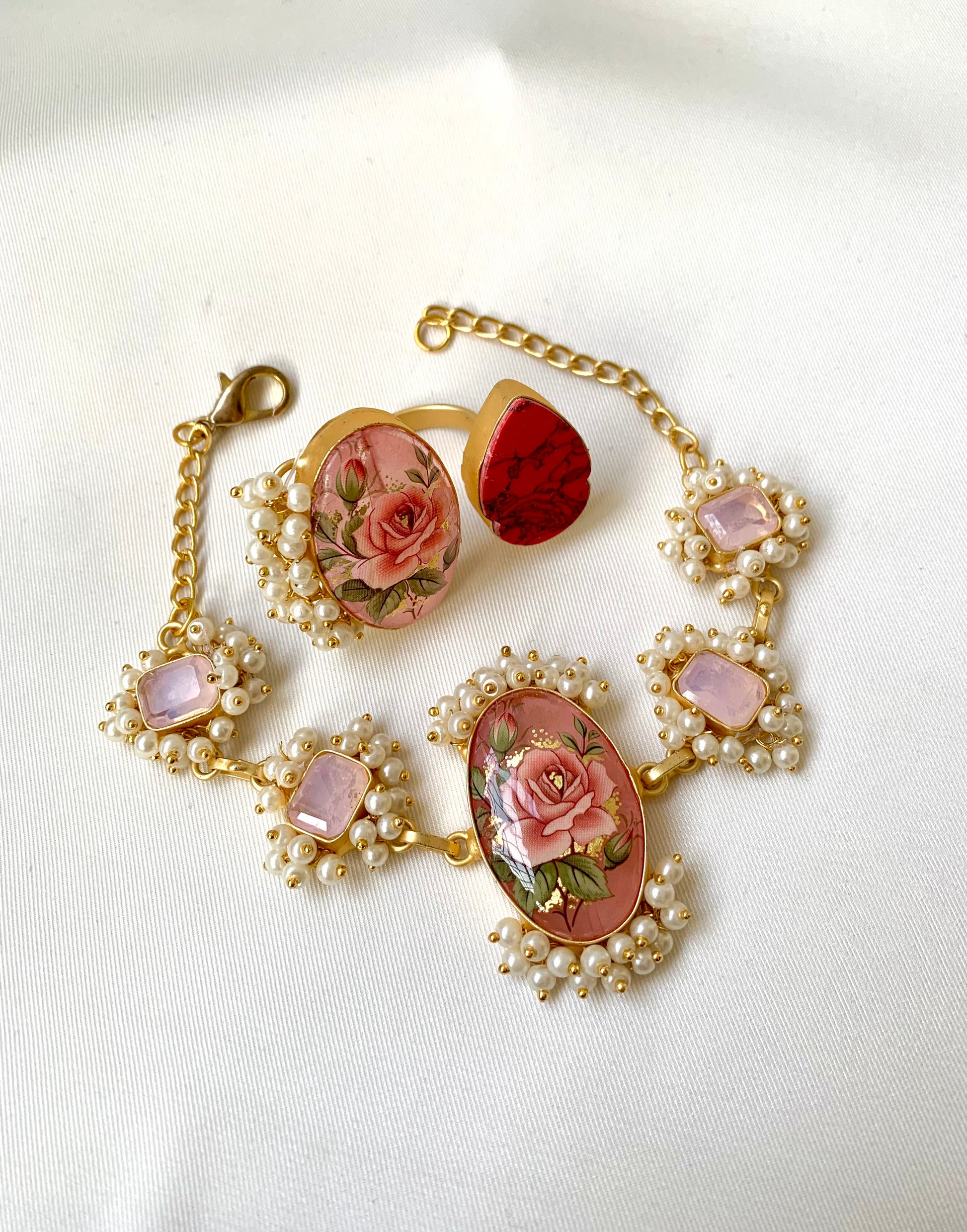 Shehnai Combo Set featuring handcrafted gold plated bracelet and adjustable ring with pearls, ruby and hand painted Tansa beads