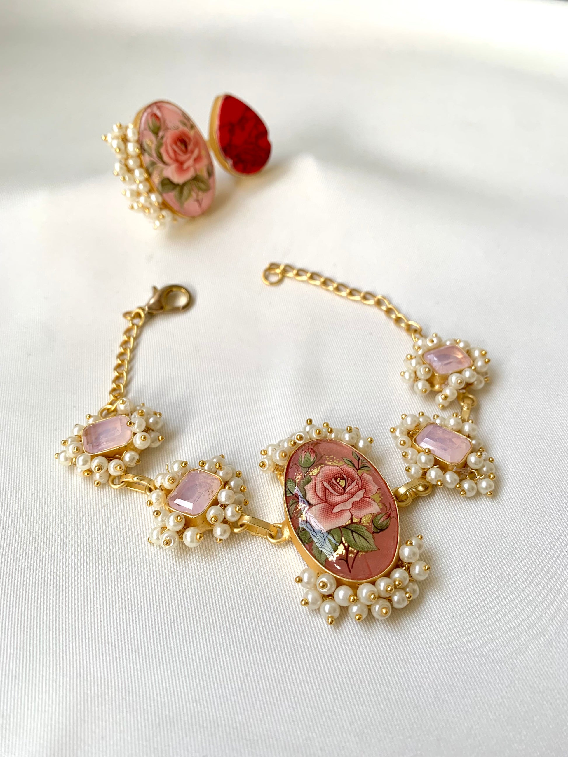 Shehnai Combo Set featuring handcrafted gold plated bracelet and adjustable ring with pearls, ruby and hand painted Tansa beads