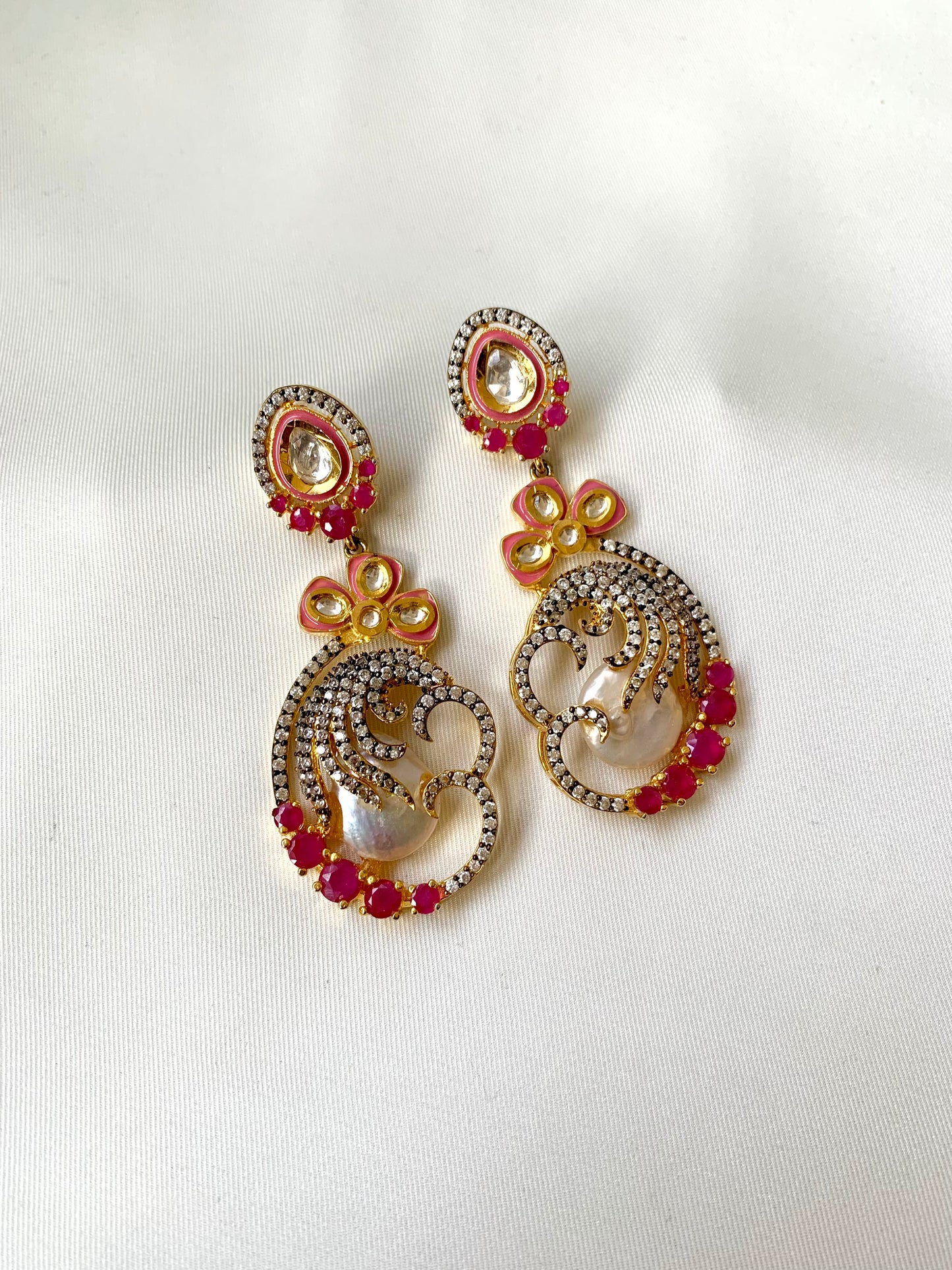 Shifa handcrafted earrings in 22kt gold with baroque pearls, ruby, American diamonds and hand painted meena
