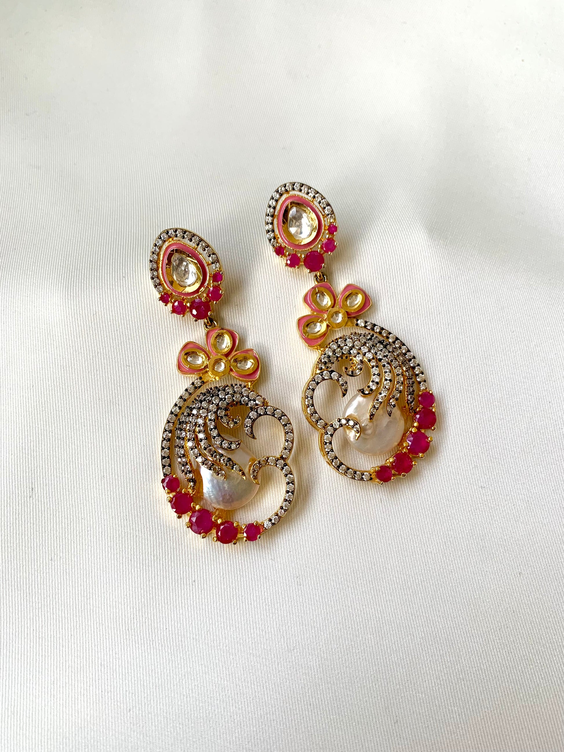 Shifa handcrafted earrings in 22kt gold with baroque pearls, ruby, American diamonds and hand painted meena