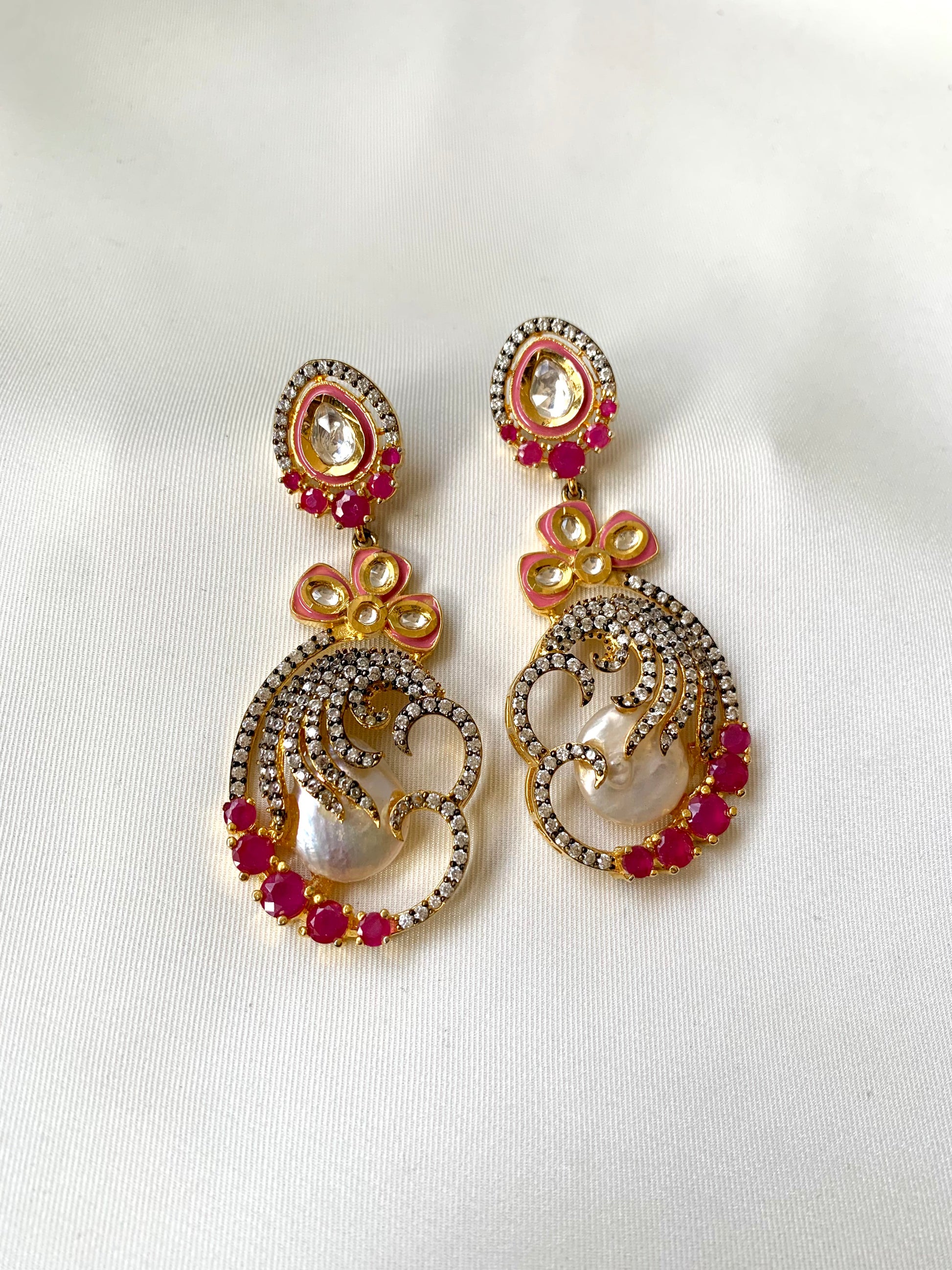 Shifa handcrafted earrings in 22kt gold with baroque pearls, ruby, American diamonds and hand painted meena