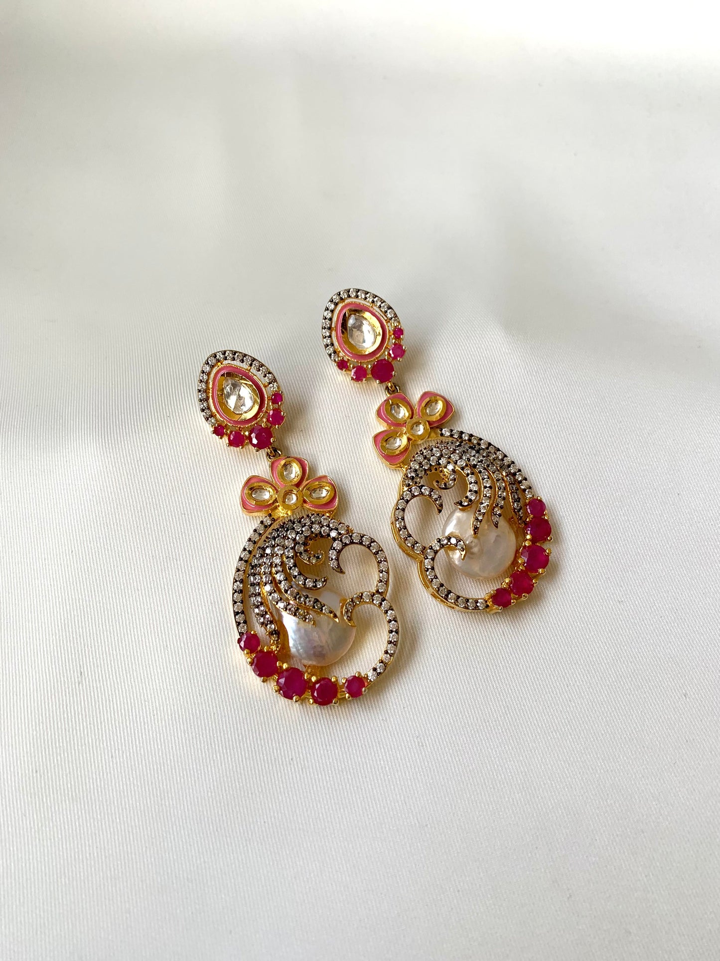 Shifa handcrafted earrings in 22kt gold with baroque pearls, ruby, American diamonds and hand painted meena