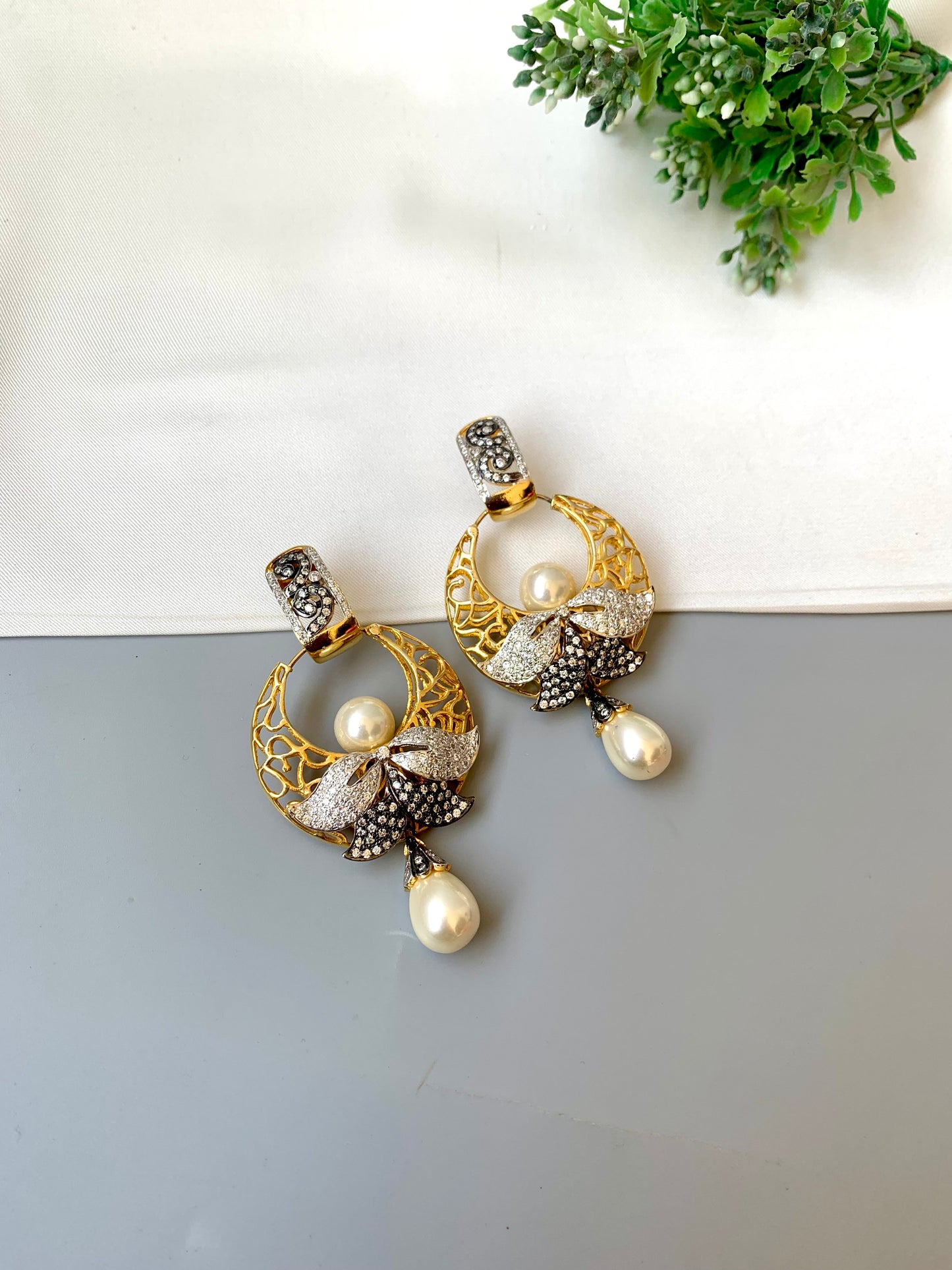 Sohai designer earrings in 22kt gold plating with oxidized polish, american diamonds and semi precious pearls