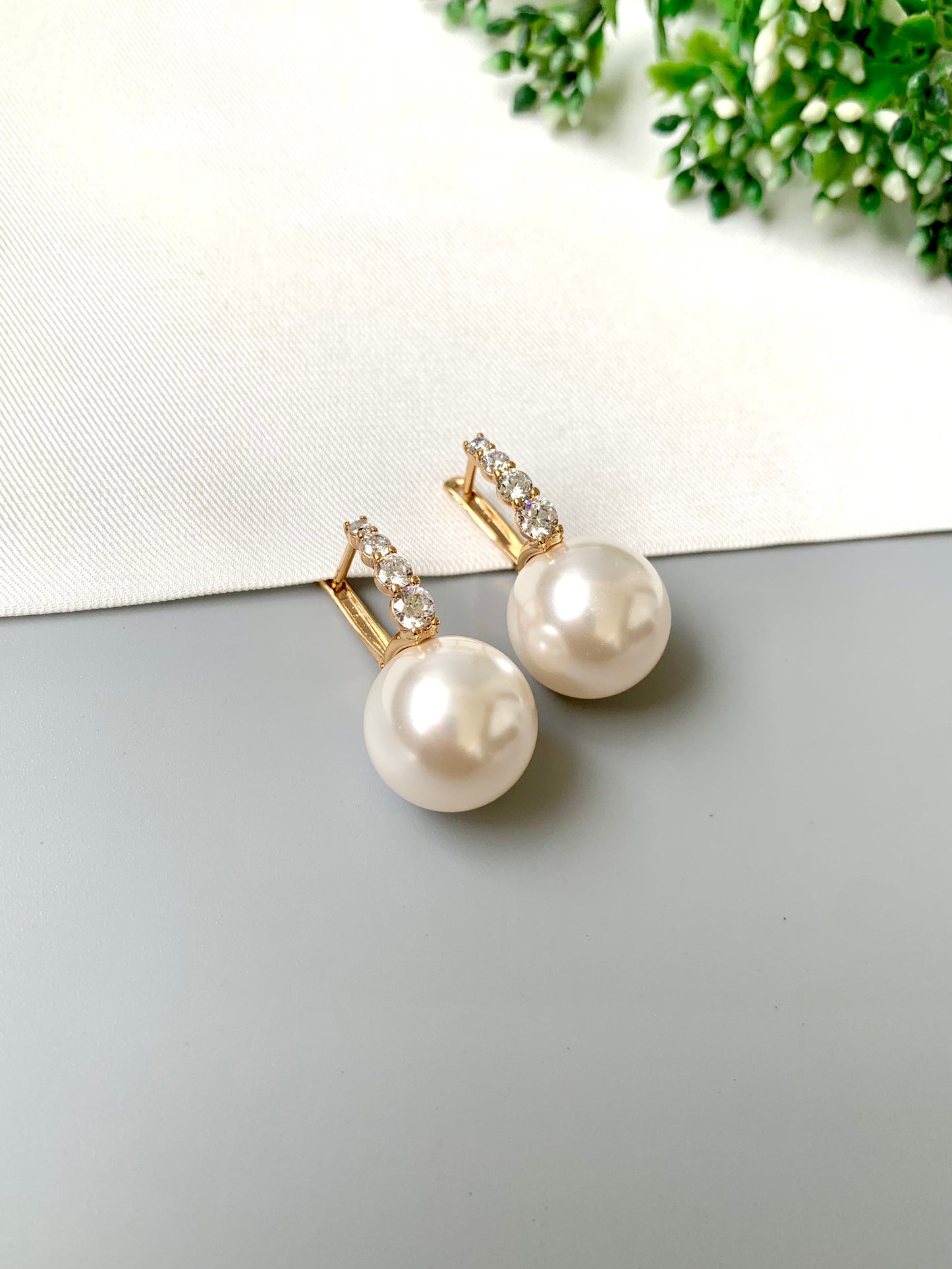Elegant gold plated pearl studs with American Diamonds – front angle