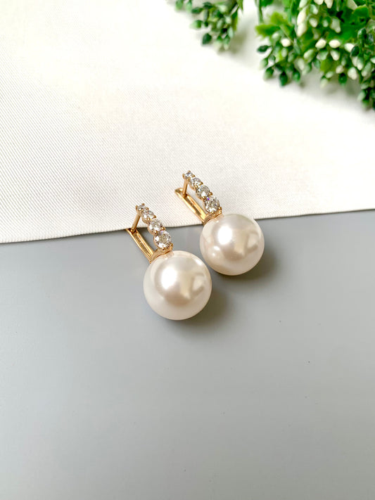 Elegant gold plated pearl studs with American Diamonds – front angle