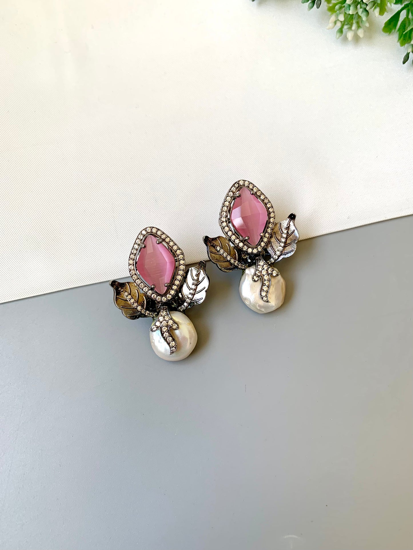 Usha pink baroque pearl studs in rhodium foil finish with onyx and american diamonds