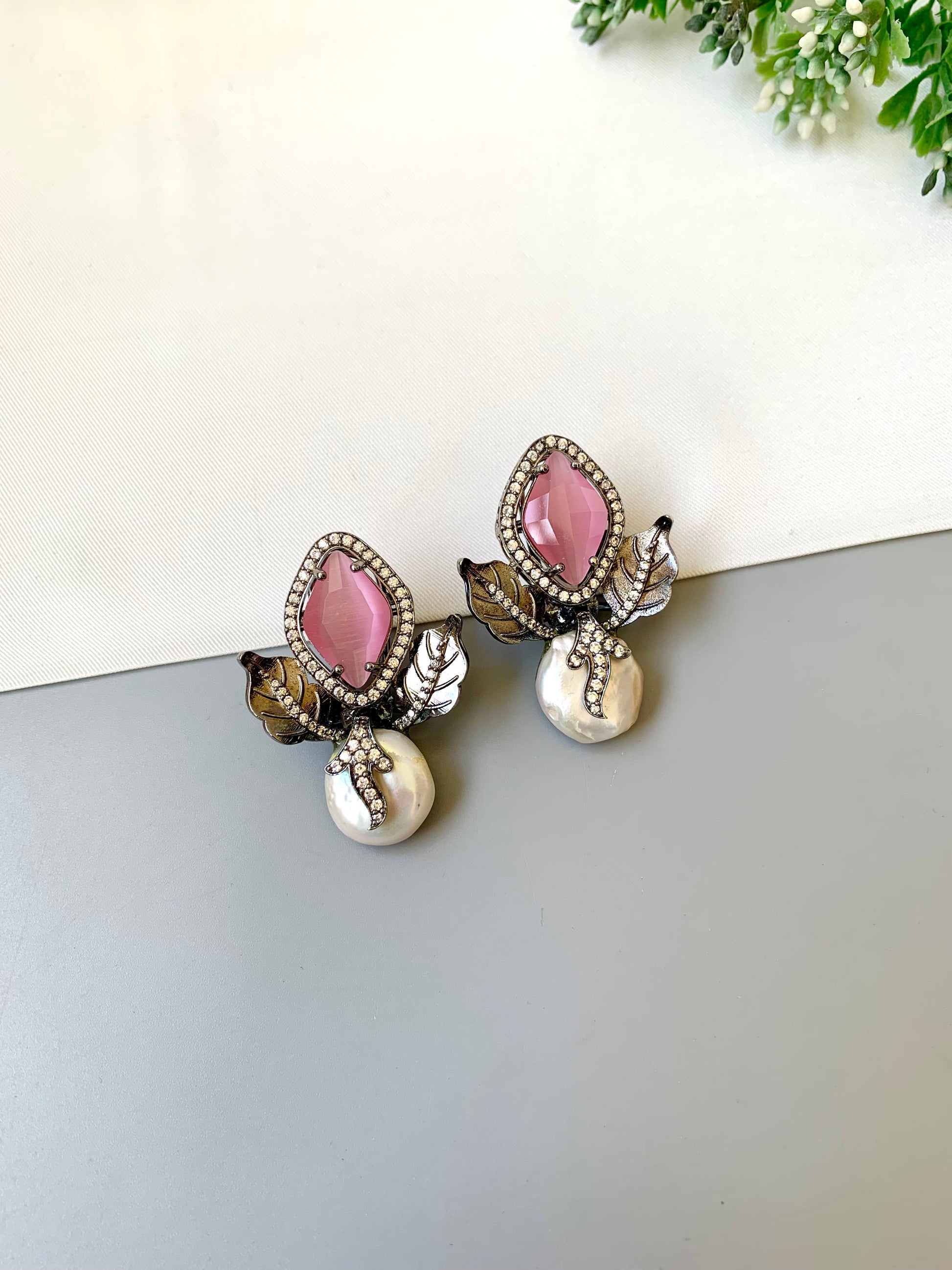 Usha pink baroque pearl studs in rhodium foil finish with onyx and american diamonds