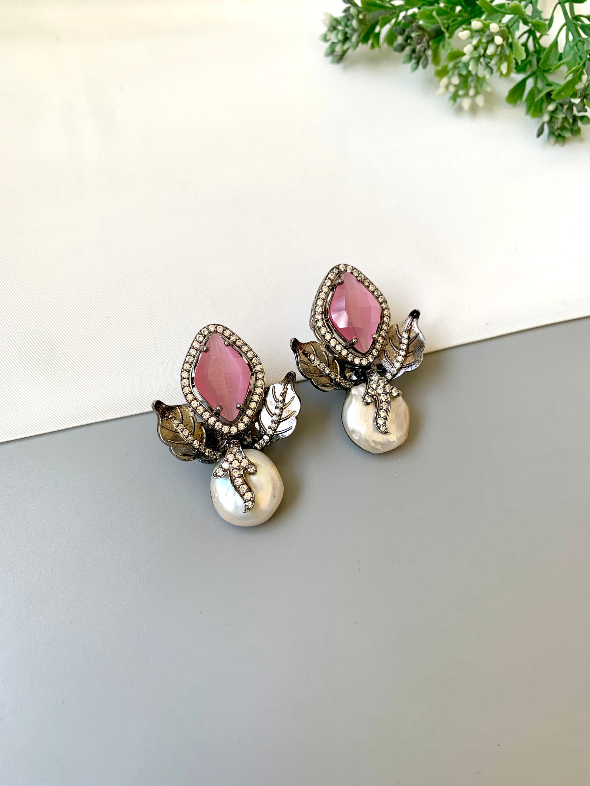 Usha pink baroque pearl studs in rhodium foil finish with onyx and american diamonds