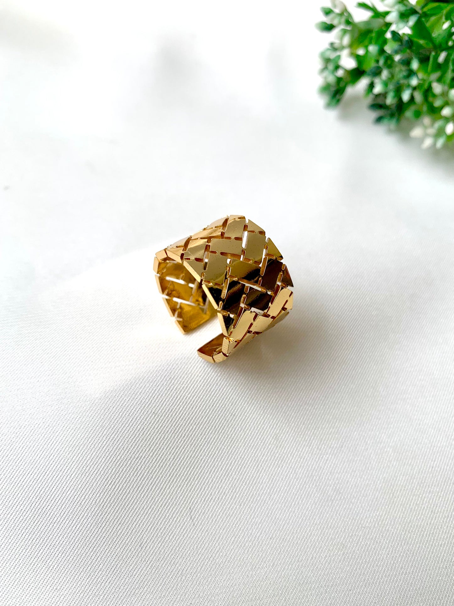 Textured gold adjustable ring with woven grid pattern from Zamal Jewels’ Forma Collection